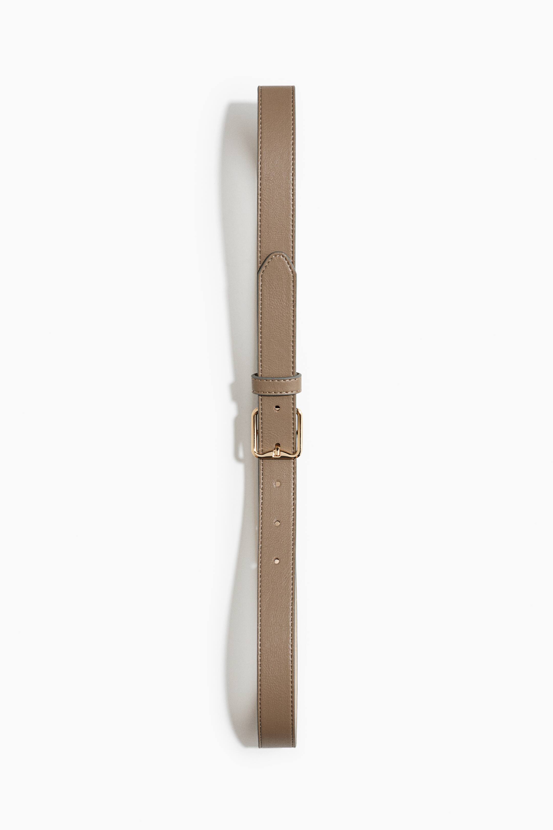 View larger image: A taupe coated fabric belt is shown facing front in a vertical arrangement, featuring a rectangular gold-toned metal buckle and a matching keeper loop. The belt displays topstitched edges and a textured finish with pre-punched adjustment holes.