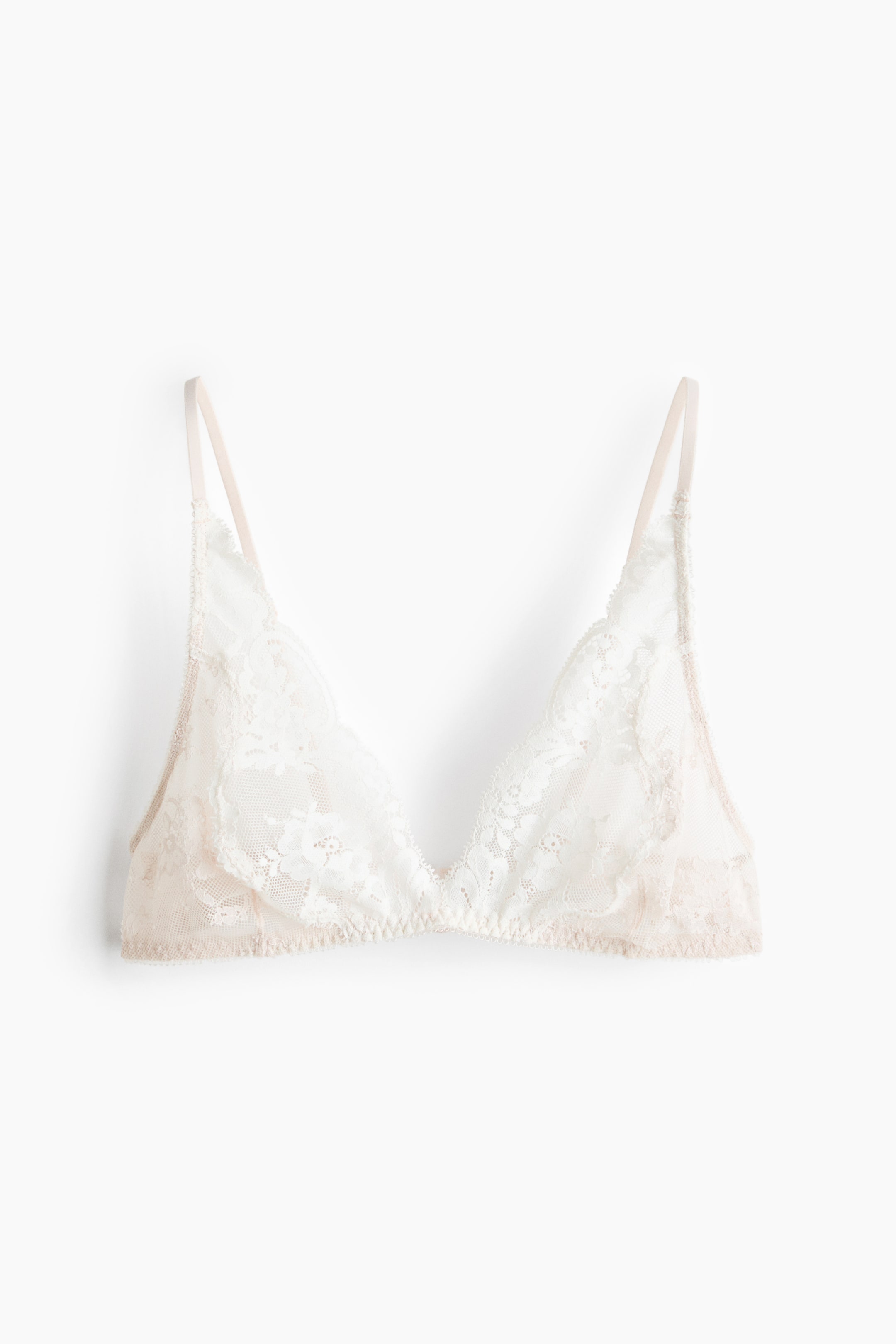 View larger image: "This soft bra showcases white embroidered lace cups paired with light nude adjustable shoulder straps. Displayed from the front, the cups create a natural silhouette."