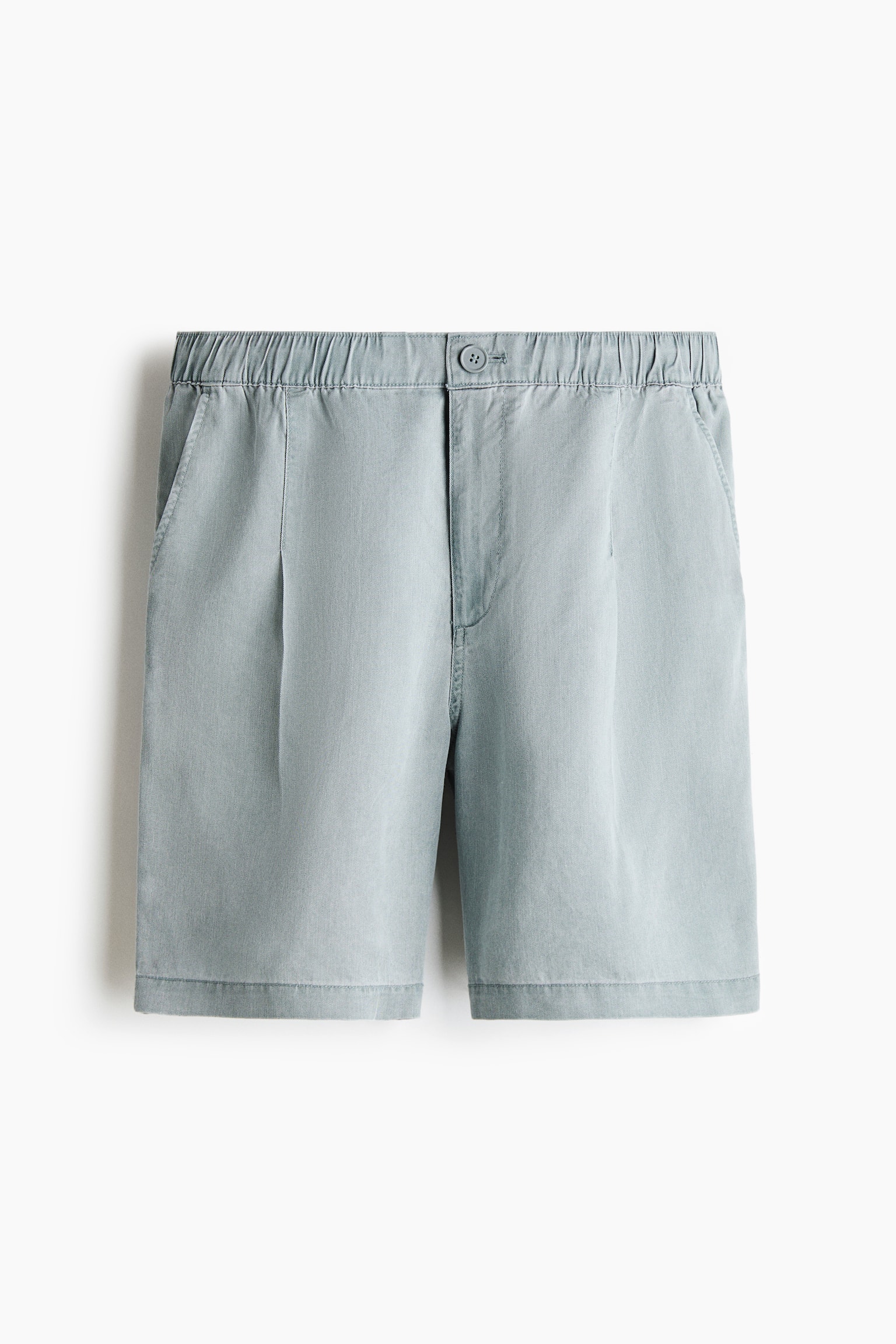 Pale blue washed shorts shown from the front. They feature an elasticated waistband, button-and-zipper closure, side pockets, and a single pleat on each leg. - 1