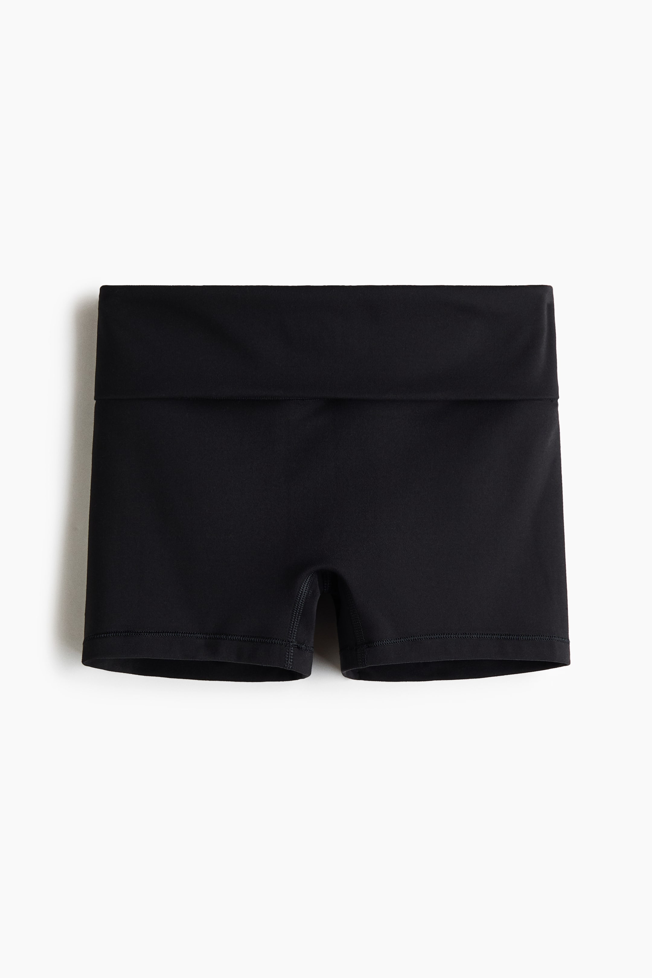 View larger image: Black athletic shorts are shown front-facing, featuring a wide, folded waistband. The shorts display short-length legs with stitched hems.