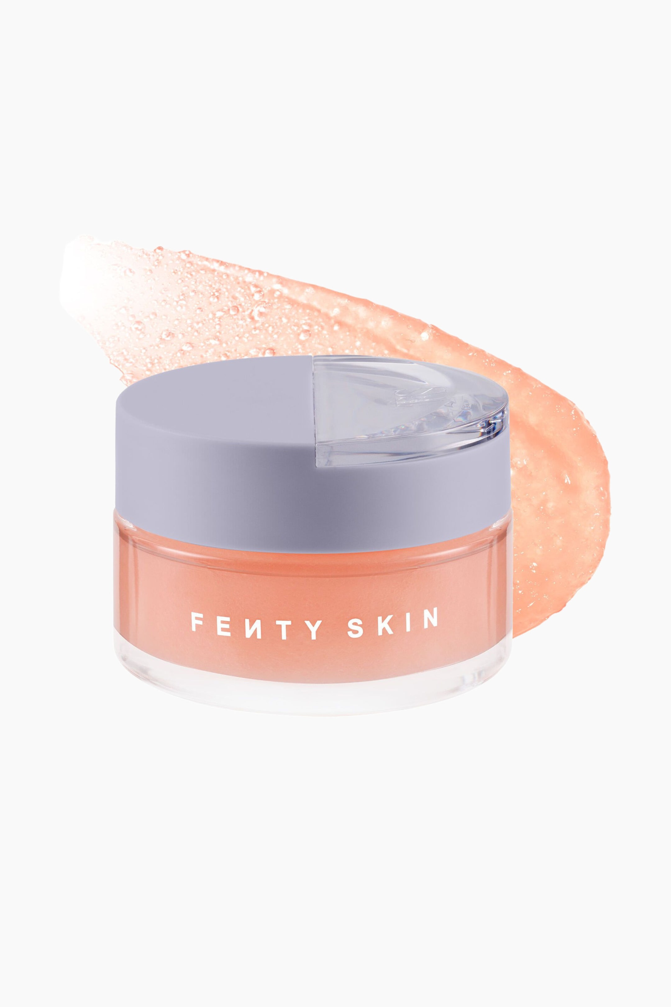 Visa större bild: Dew N Plump Slushie Overnight Face Mask är placerad framåt i en klar burk med ett lavendelgrått lock, vilket visar den persikofärgade formulan inuti. Ett texturerat, halvtransparent prov av den persikofärgade gelen böjer sig diagonalt bakom burken för att visa dess slushie-liknande konsistens.