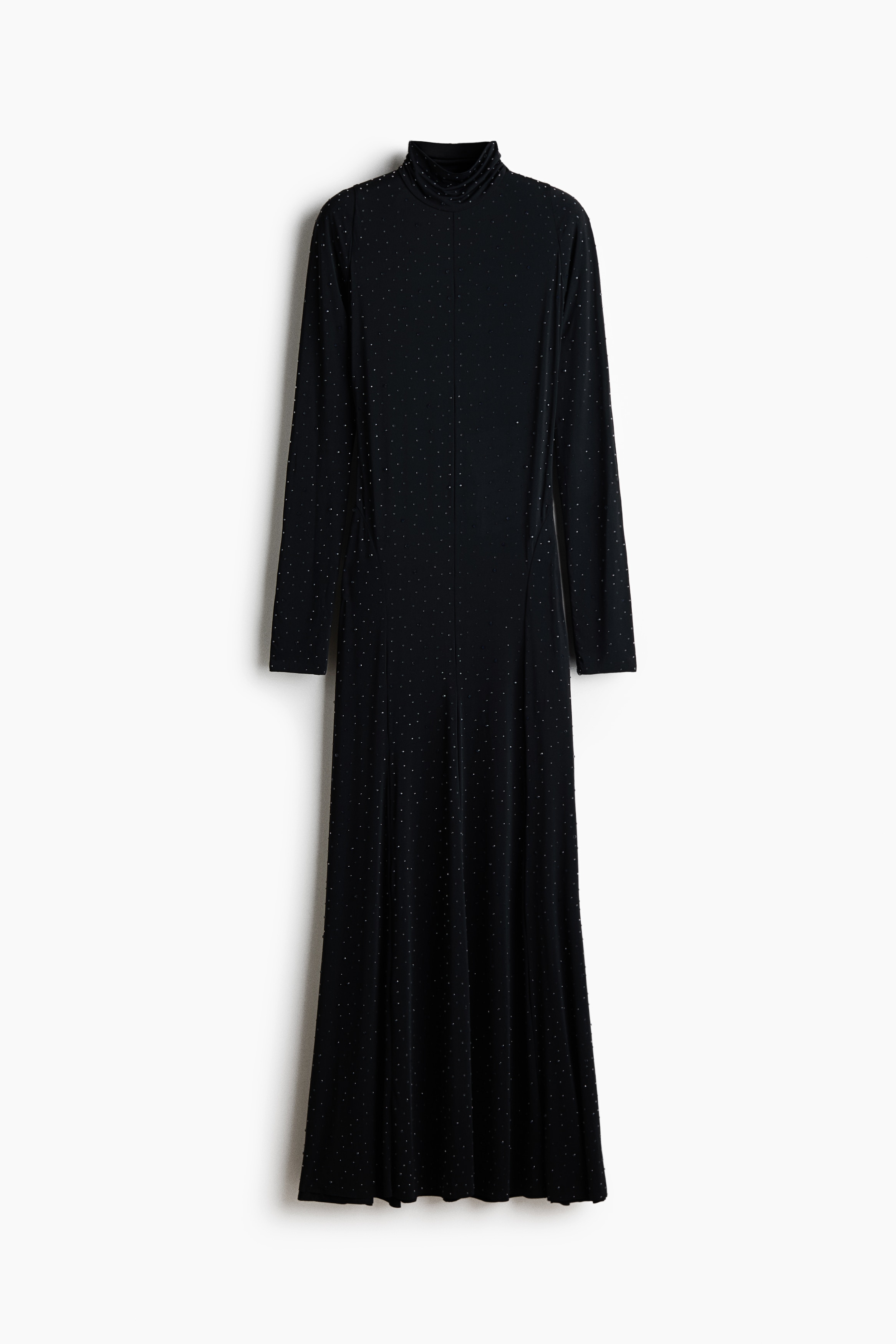 A black high-neck dress covered in small, sparkling rhinestones is being worn by the model, who is holding their hands together at the waist. The dress features long sleeves with a stacked effect at the wrists and a visible center seam, styled with a black structured hat.