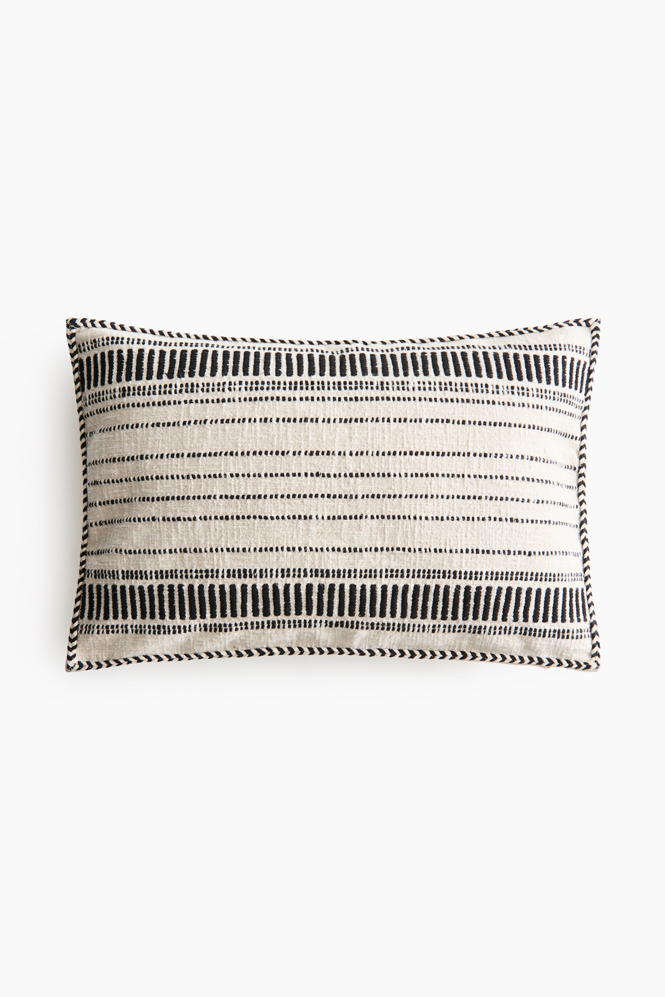 View larger image: "A rectangular cushion cover showcases its front, crafted from a rustic cotton weave with a textured pattern of black horizontal dashes and vertical bars on a light background. A black and white braided trim finishes the edges."