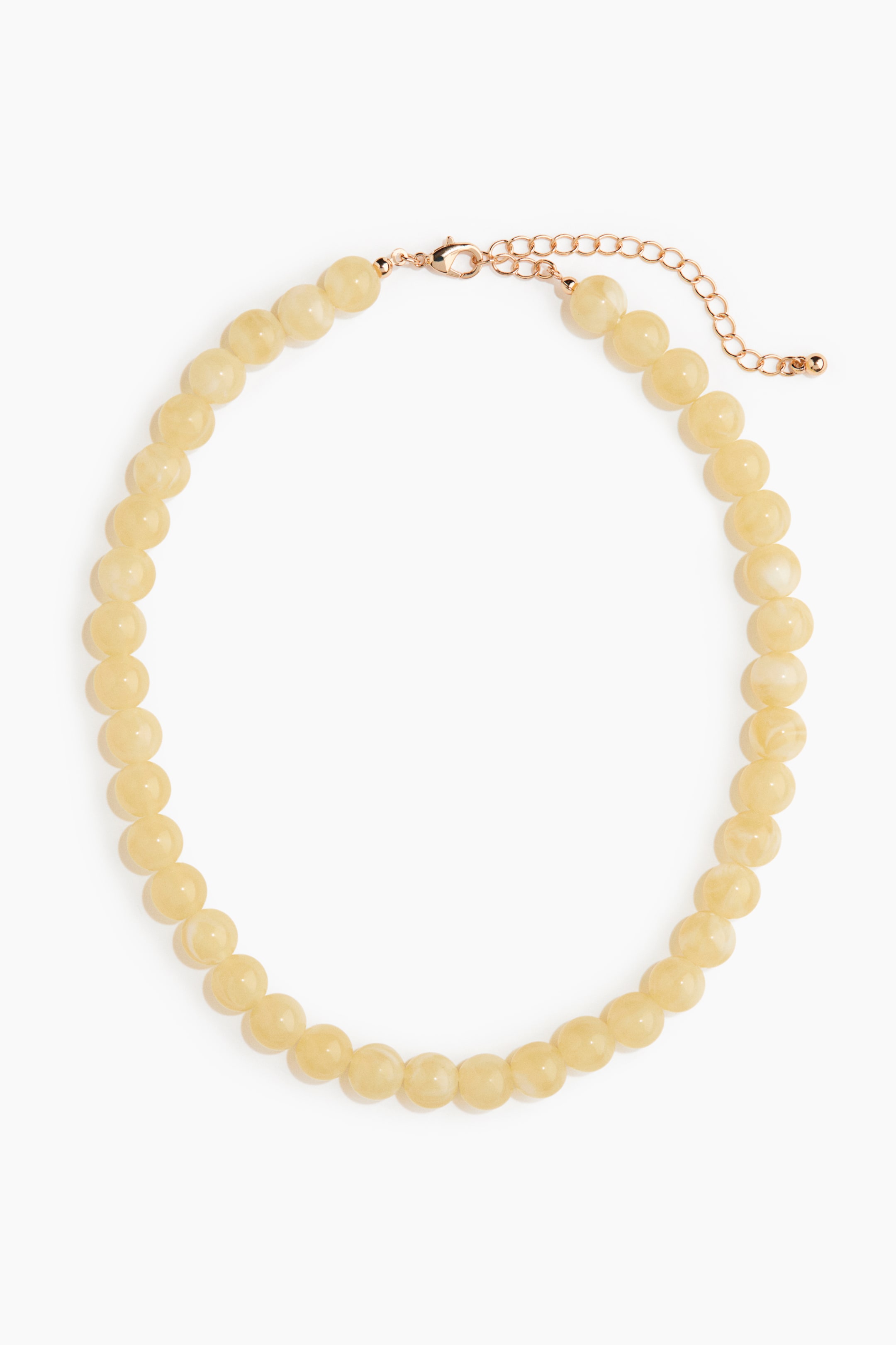 View larger image: A beaded necklace showcases round, light yellow beads with a subtle marbled appearance, featuring a rose gold-toned adjustable extender chain and a trigger clasp.
