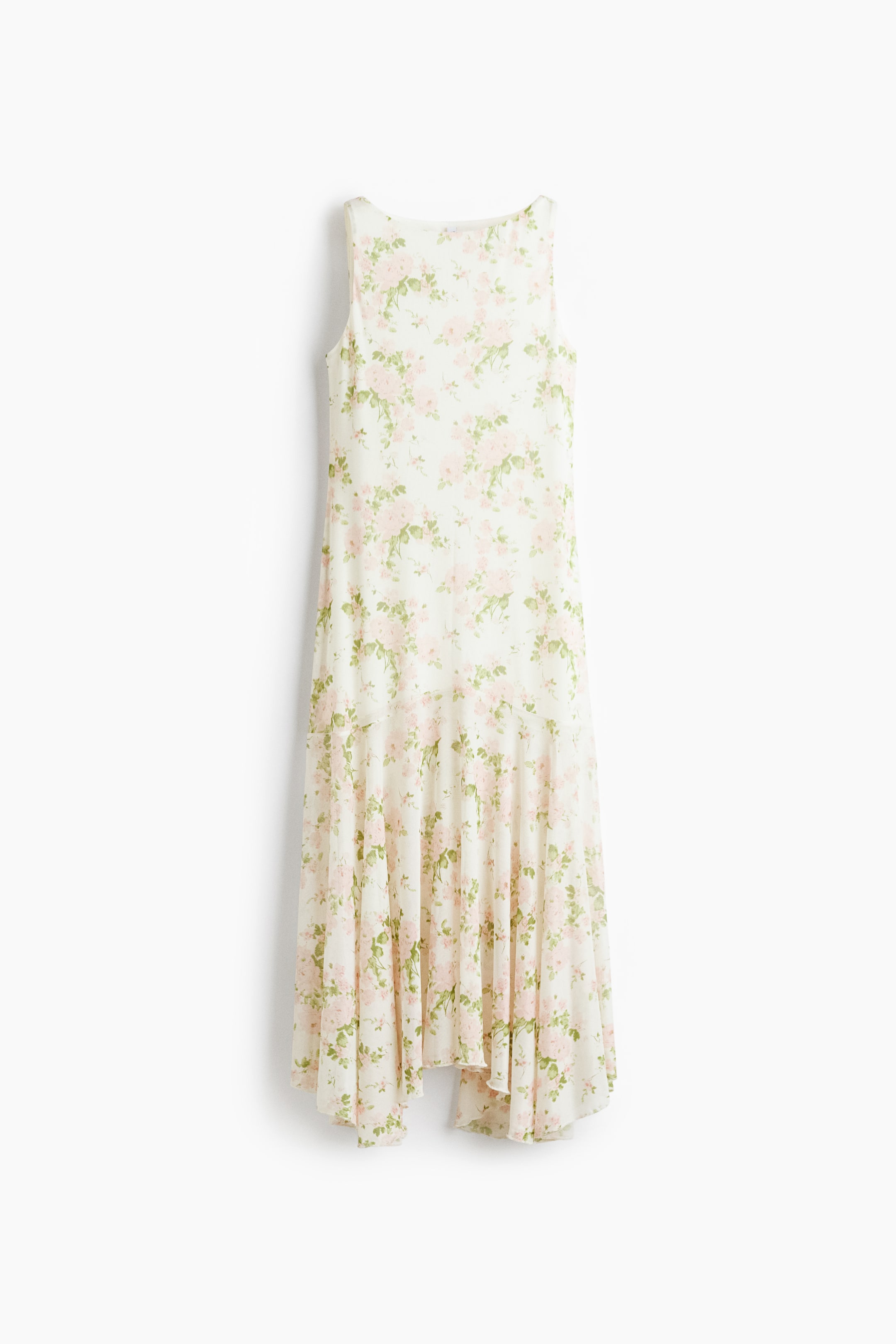 View larger image: A sleeveless dress showcasing a delicate floral pattern of pink roses and green leaves on a cream backdrop, displayed from the front. It is crafted with a fluid silhouette and concludes with an asymmetrical handkerchief hemline.
