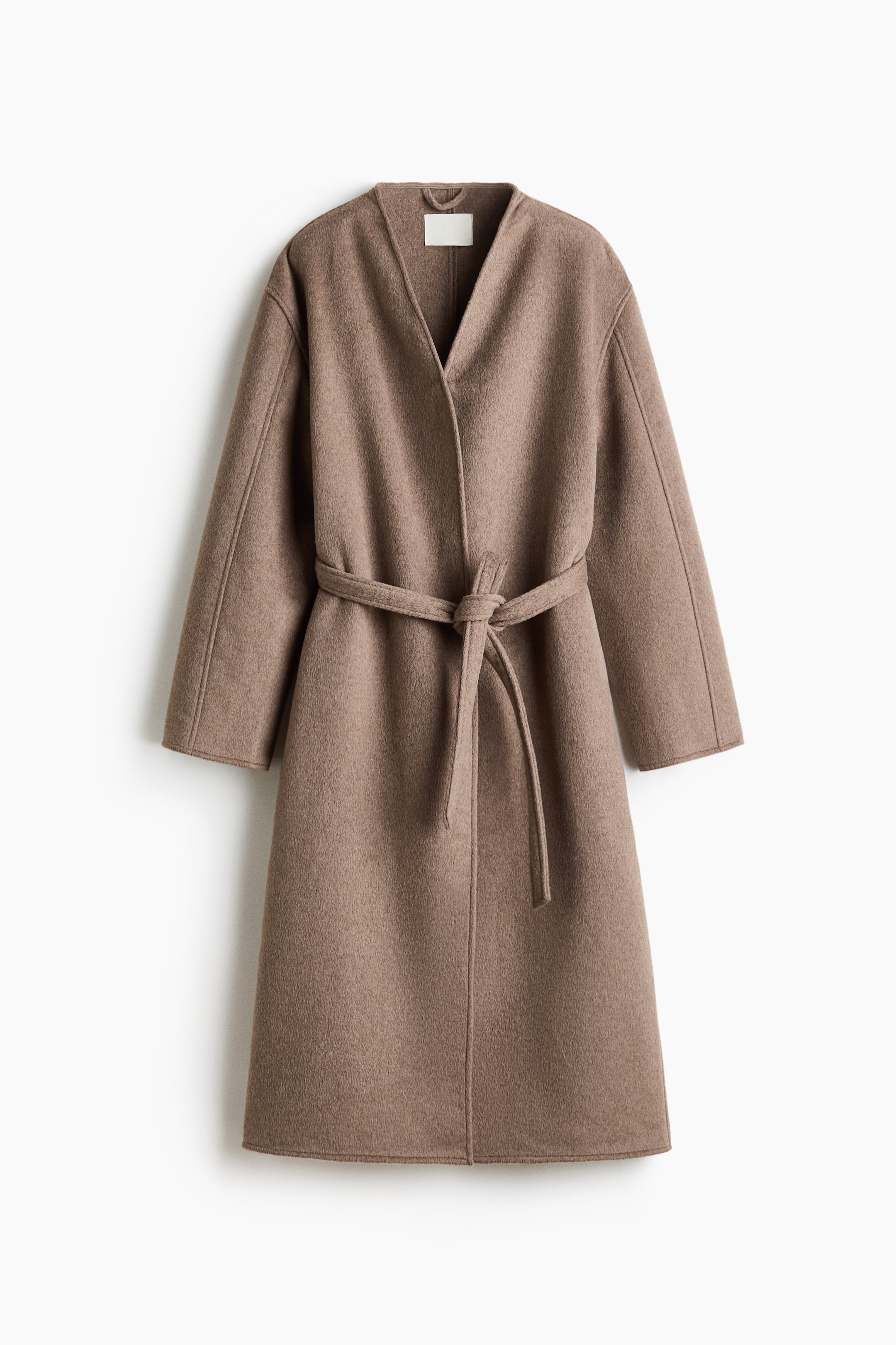 View larger image: A taupe wrap coat is shown from the front, featuring a V-neckline and long sleeves. A tie belt is knotted at the front, defining the waist of the textured, felted coat, which falls to knee length.