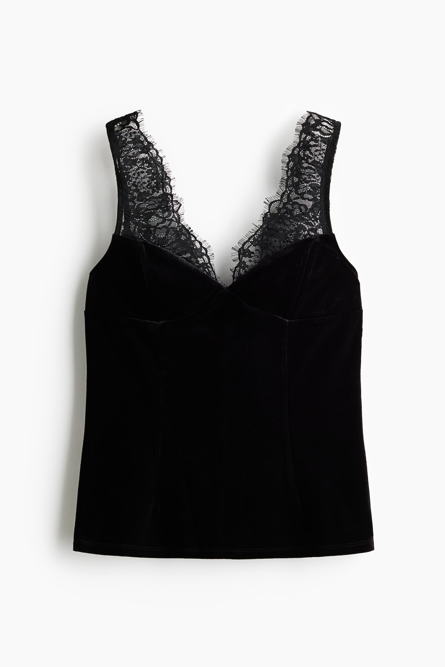 Ein schwarzes Samt-Camisole ist von vorne zu sehen und verfÃ¼gt Ã¼ber ein figurbetontes Oberteil mit formgebenden PrinzessnÃ¤hten sowie einen herzfÃ¶rmigen V-Ausschnitt. Der Ausschnitt und die breiten SchultertrÃ¤ger sind mit zarter schwarzer Spitze verziert, deren Kanten mit Wimpernabschluss gearbeitet sind.