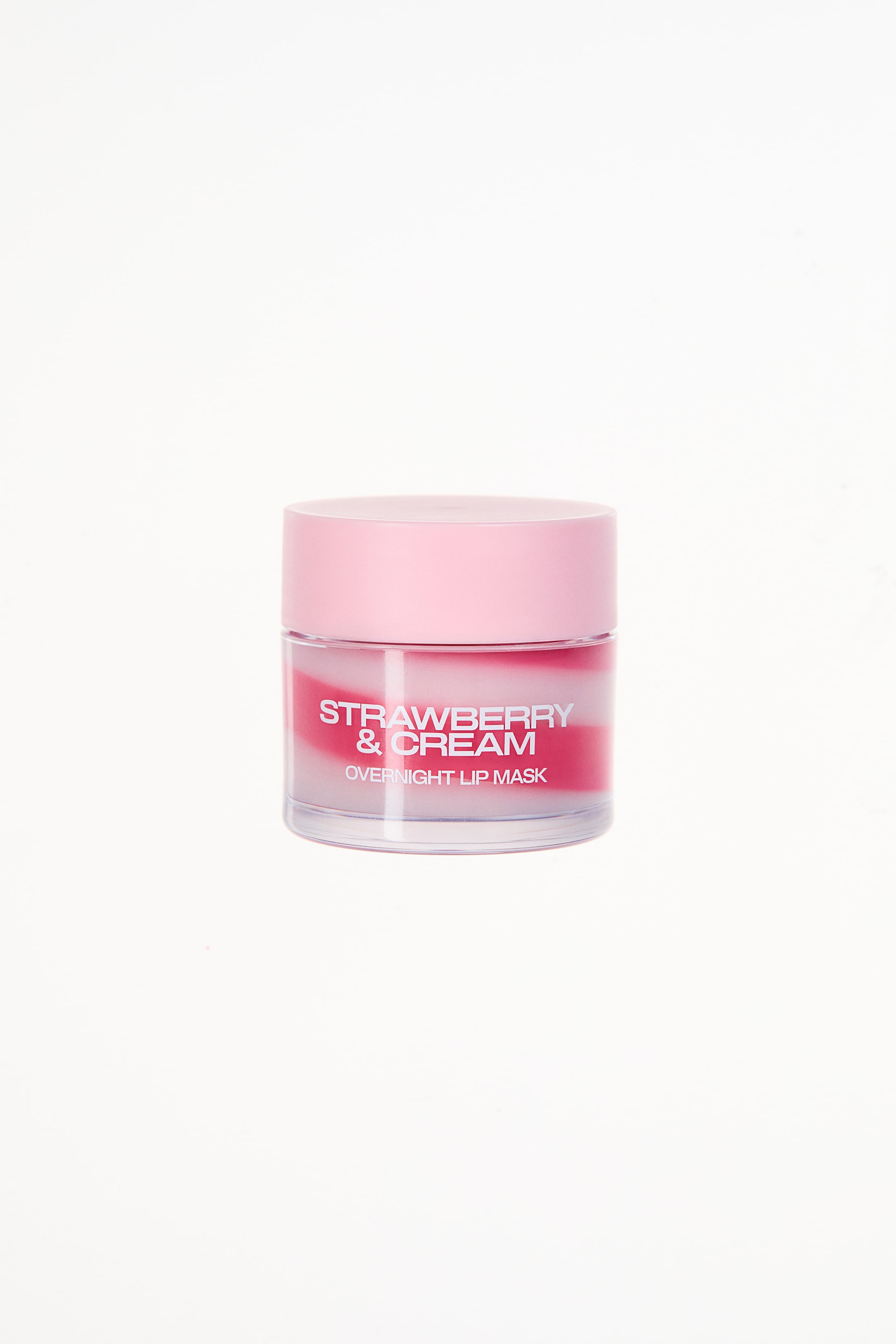 View larger image: A clear, round jar of Strawberry & Cream Overnight Lip Mask is positioned facing forward, slightly angled to the right. It features a pink lid and displays the visible pink and white swirled product, with the label reading "Strawberry & Cream" above "Overnight Lip Mask."