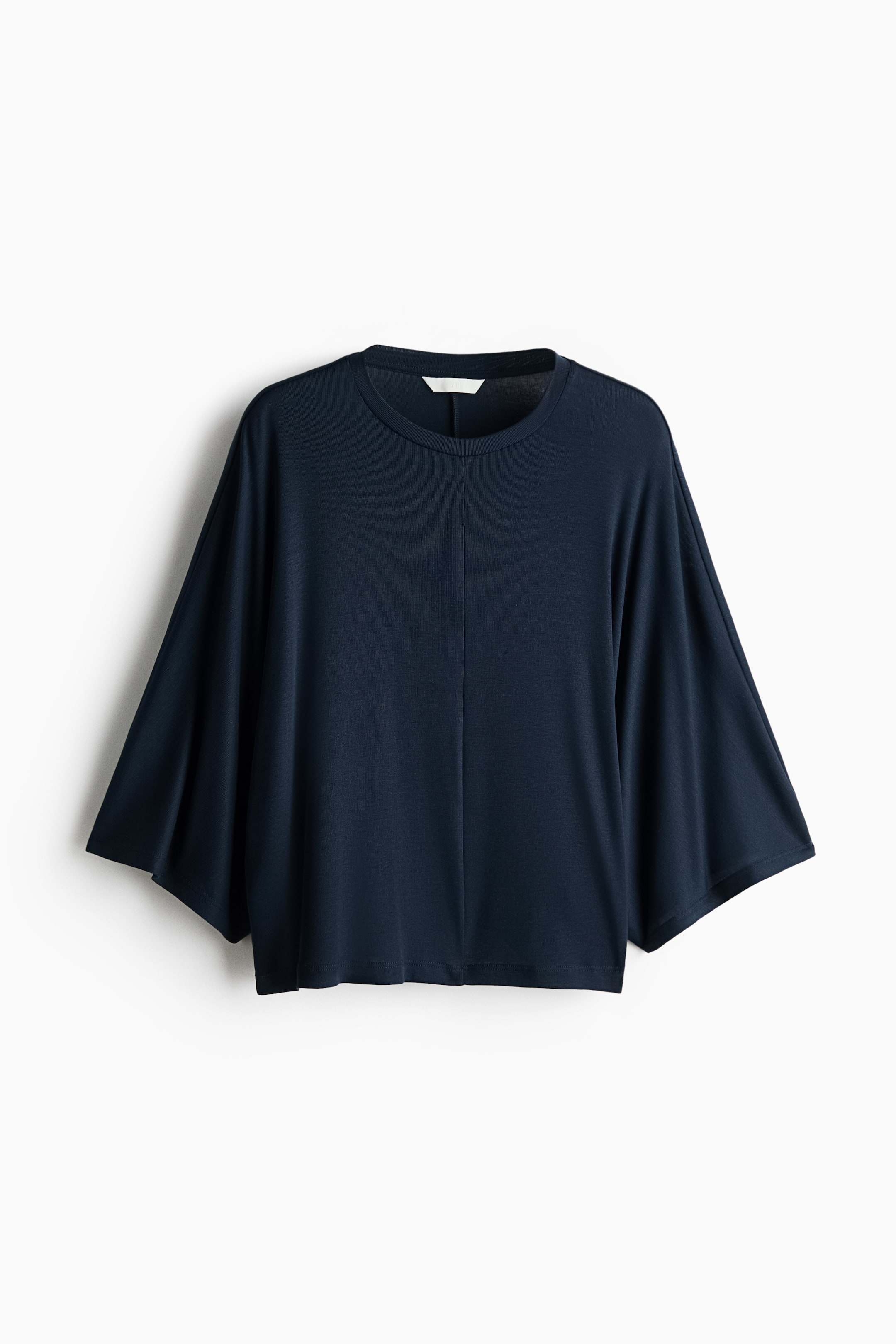 View larger image: A dark blue top showcases its front, boasting a crew neck, wide dolman sleeves, and a noticeable vertical seam running down the center.