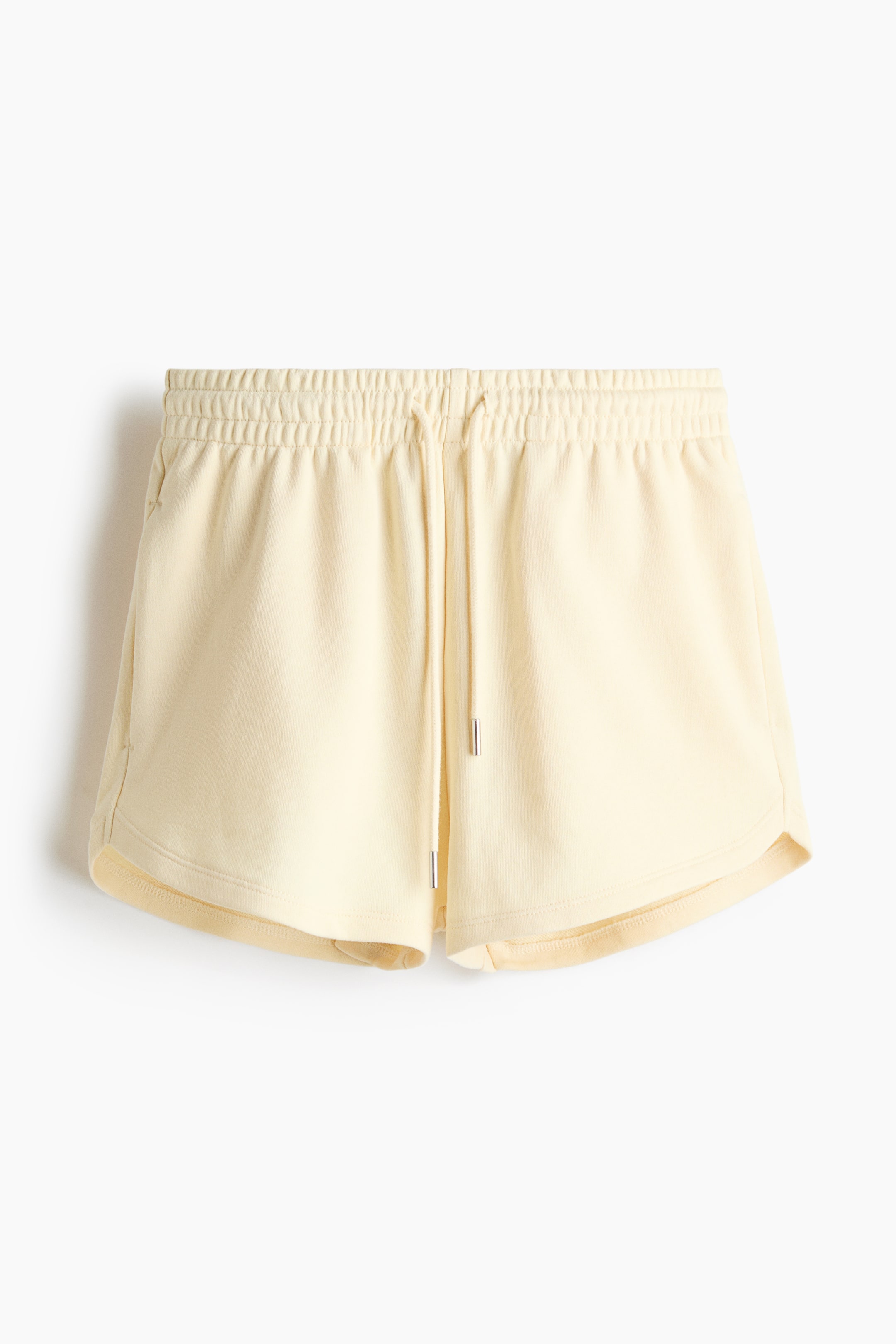 View larger image: These light yellow shorts are displayed from the front, crafted from a lightweight sweatshirt-style fabric. They feature a gathered elastic waistband with a drawstring that has silver-toned tips, and discreet pockets are visible along the side seams.