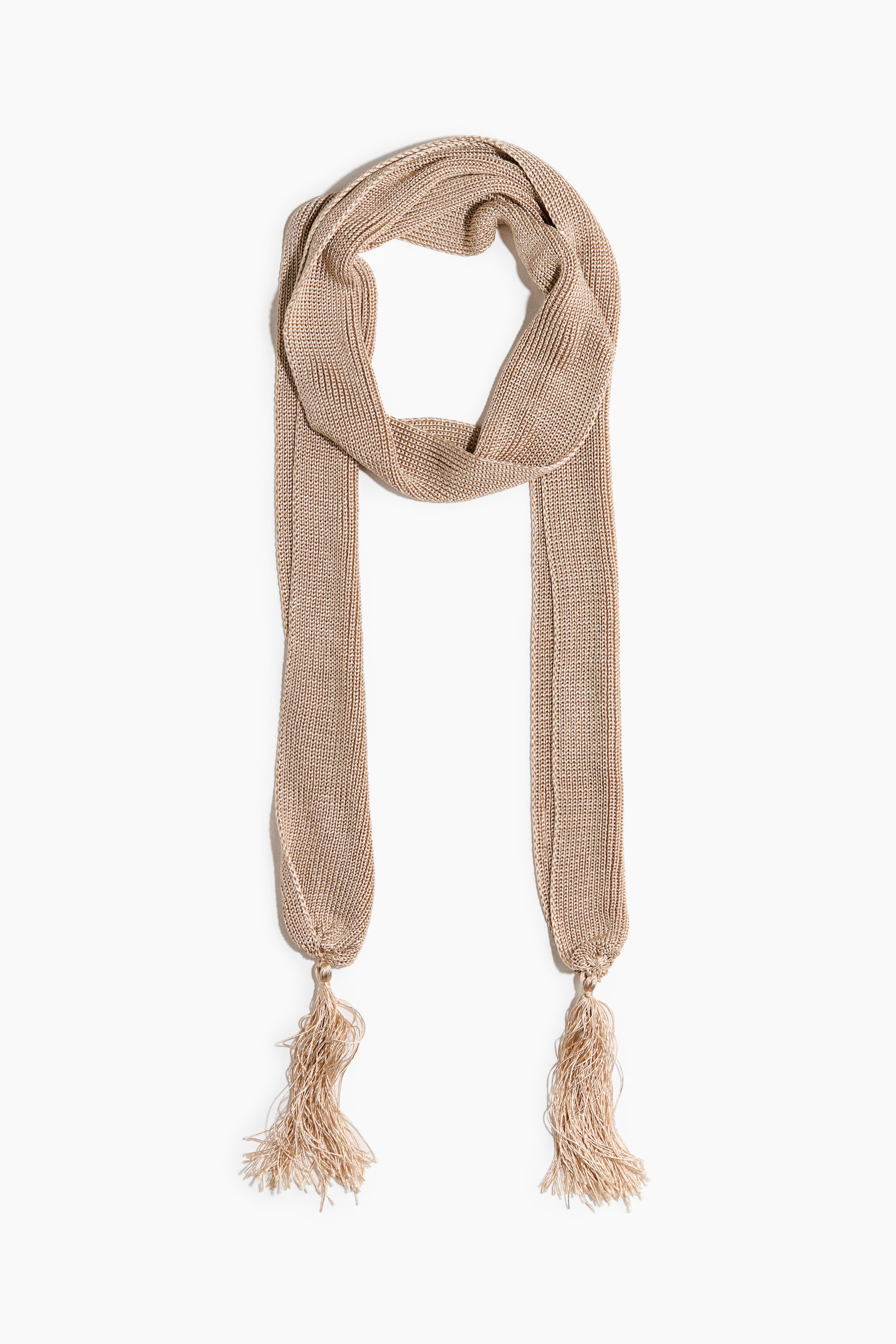 View larger image: A light tan, shimmering fine-knit scarf is draped in a U-shape, with its two long ends extending downward. Each end is gathered, and a matching tassel is attached.