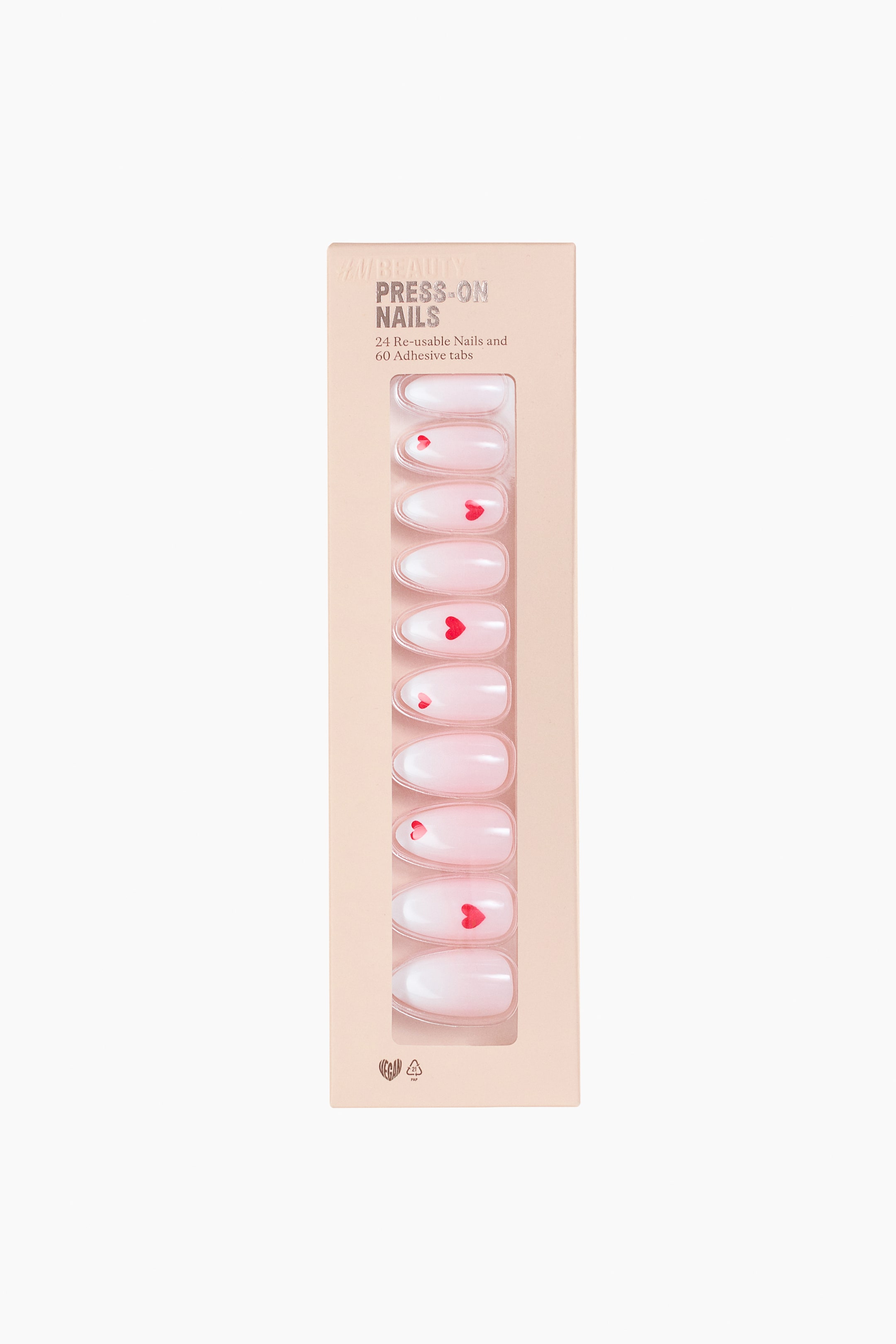 View larger image: A rectangular light peach package of press-on nails is presented FRONT, featuring printed text stating "24 Re-usable Nails and 60 Adhesive tabs." 