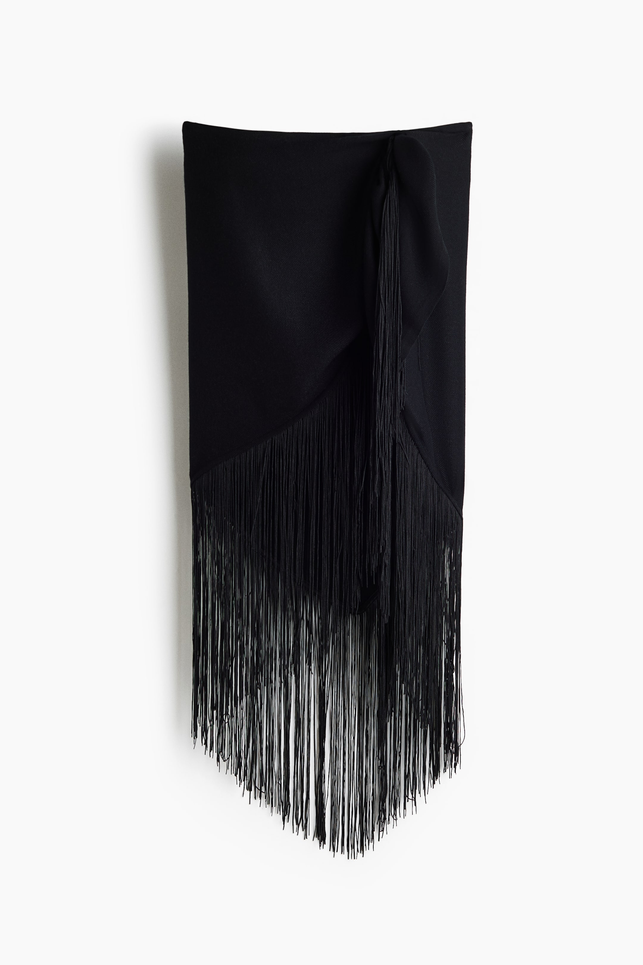 View larger image: A black triangular scarf in twill is showcasing its front, with long, dense fringes adorning its two angled sides.