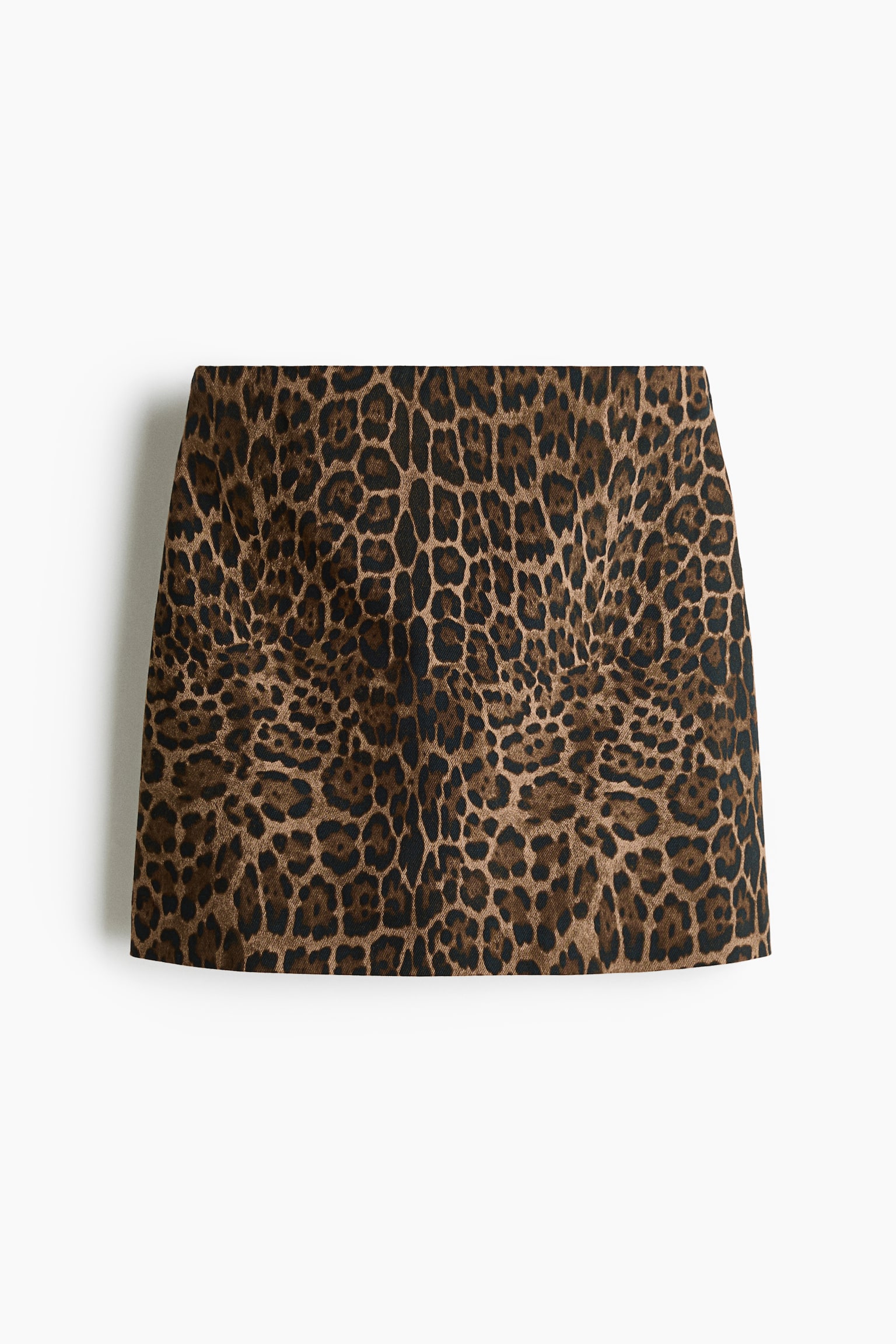 A high-waisted mini skirt featuring an all-over leopard print in shades of brown and black is shown from the front. The skirt is made of cotton twill, presenting a structured silhouette with a clean, seamless waistband. - 1