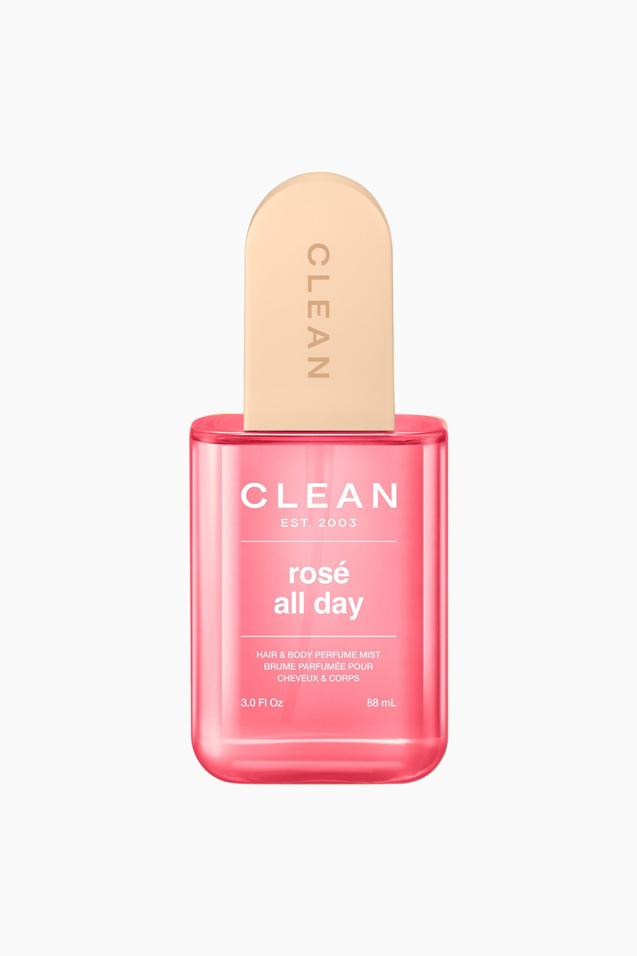 Se større billede: En gennemsigtig, rektangulær flaske med lyserød "rosé all day" hår- og kropsparfumespray står oprejst og vender fremad. Den har en lys beige, afrundet topkapsel med "CLEAN" præget lodret på siden.