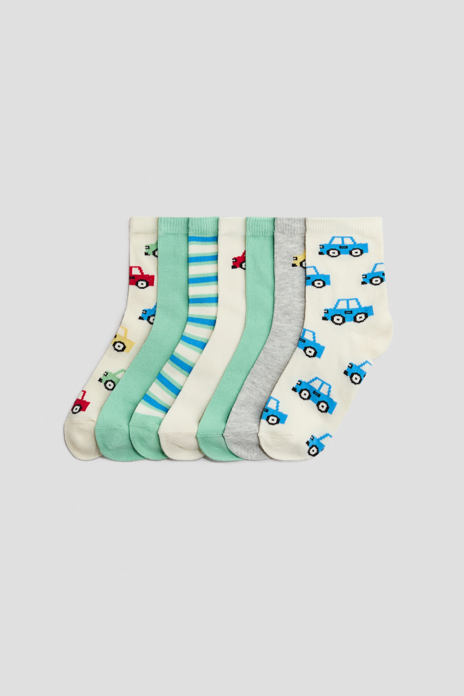 Skarpety 7-pak - Zielony/Auta/Zielony/Dinozaury/Niebieski/Piłki nożne/Ciemnoniebieski/Burgery/Biały/Jamnik/Szary/Samochody/Niebieski/Dinozaury/Zielony/Niedźwiedzie/Granatowy/Dni tygodnia/Zielony/Tygrysy/Zieleń khaki/Dinozaury/Żółty/Dinozaury