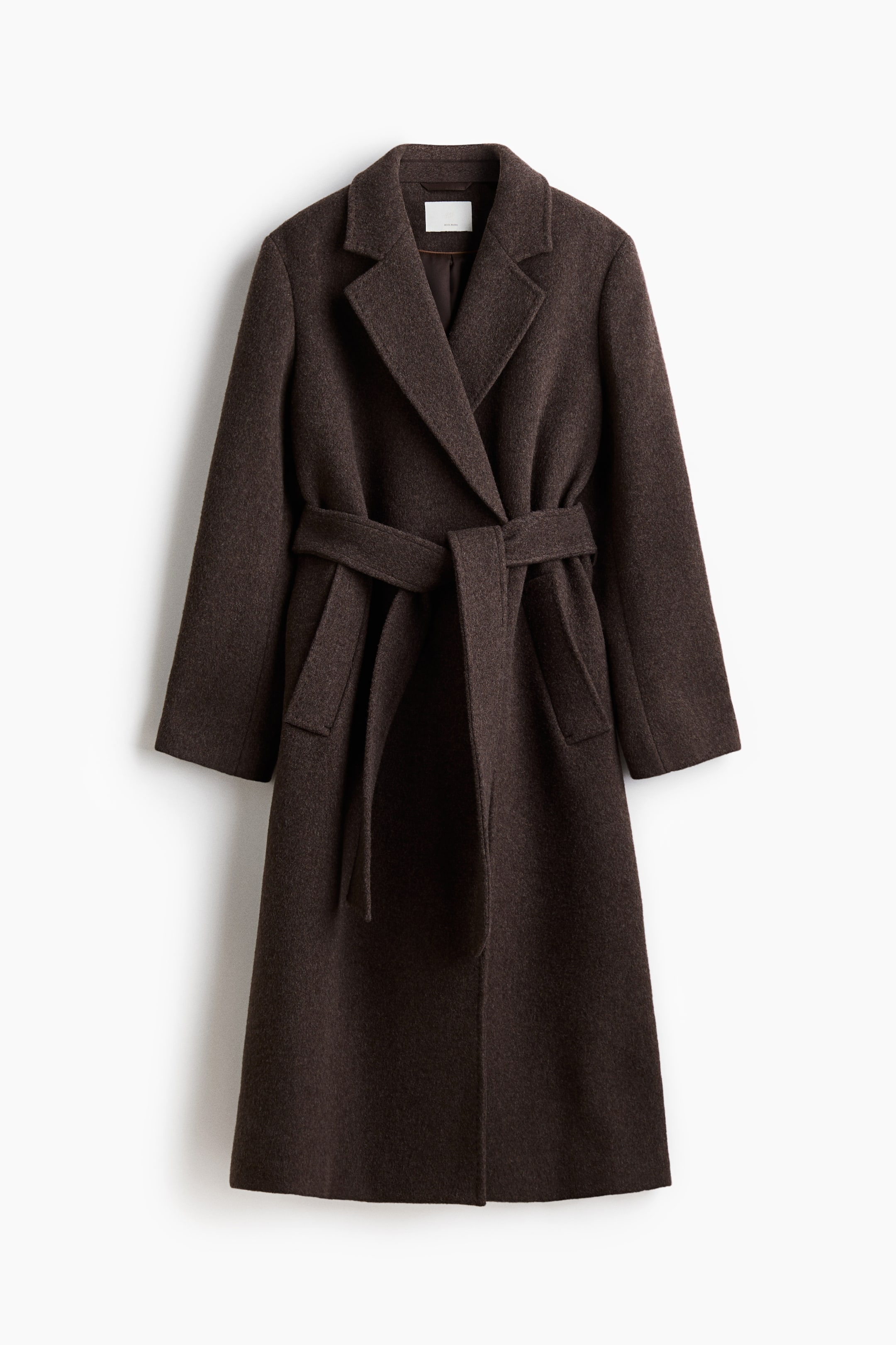 View larger image: A calf-length dark brown coat in a felted wool blend is displaying a wrapover FRONT with structured shoulders and notch lapels. A wide tie belt is cinching the waist, and long sleeves and welt side pockets are visible.