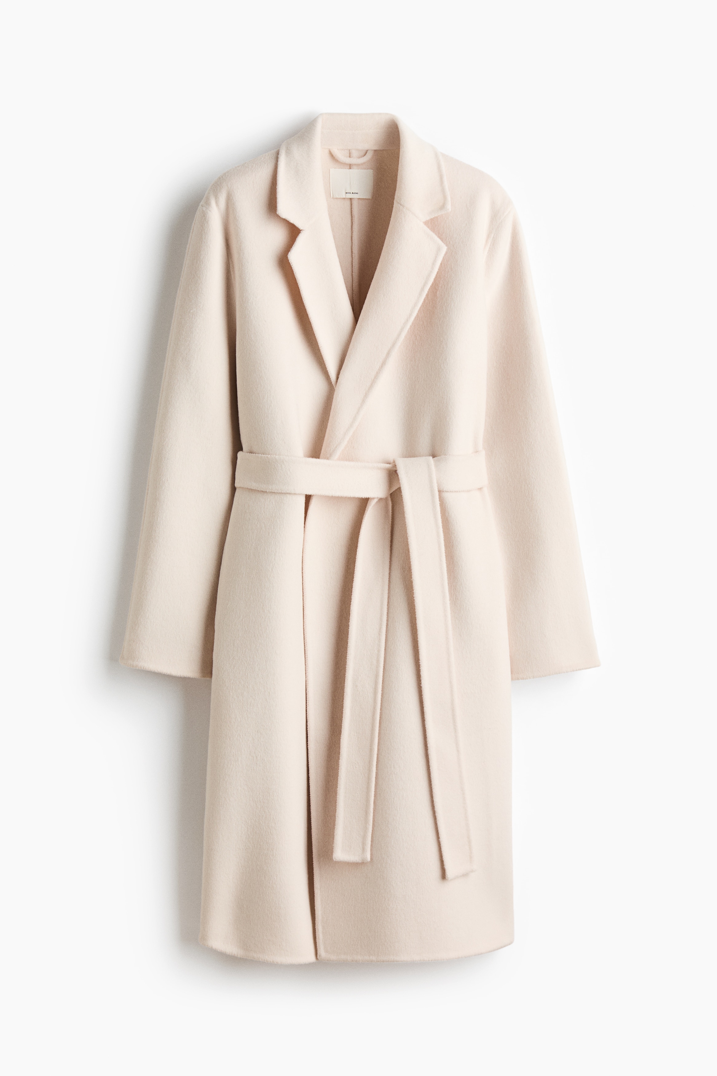 Håndsyet frakke i uldblanding - Creme