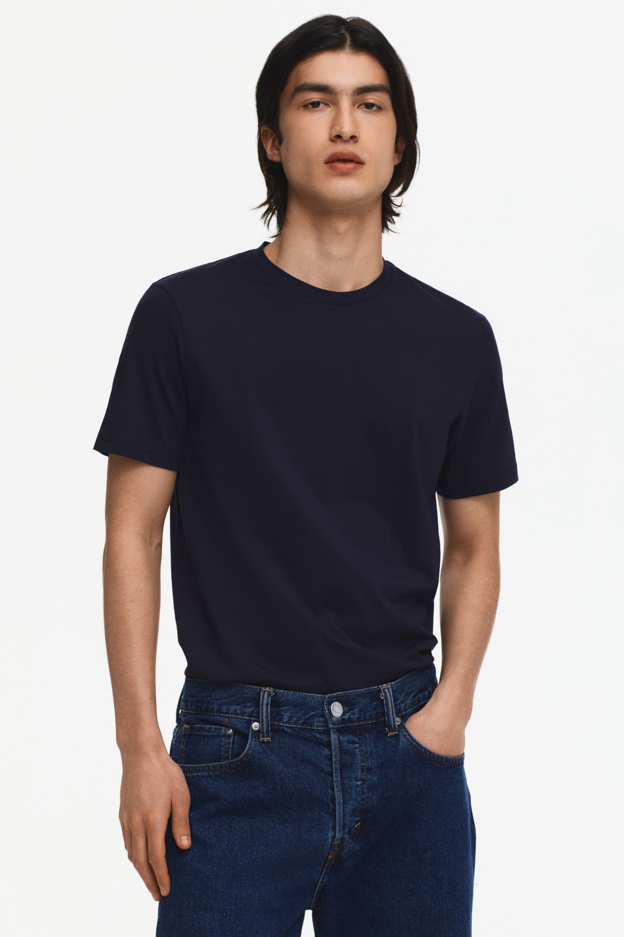 View larger image: "This navy crew neck t-shirt features a regular fit and short sleeves, styled tucked into dark wash jeans."