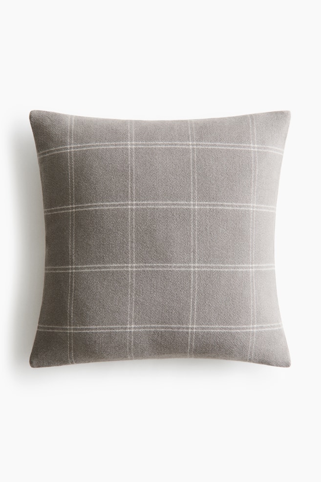 A rectangular gray pillow is featuring a light gray windowpane plaid pattern. - 1