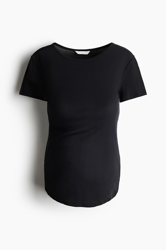A black ribbed knit T-shirt is shown from the front, featuring a scoop neckline, short sleeves, and a fitted silhouette with a curved hem. - 1
