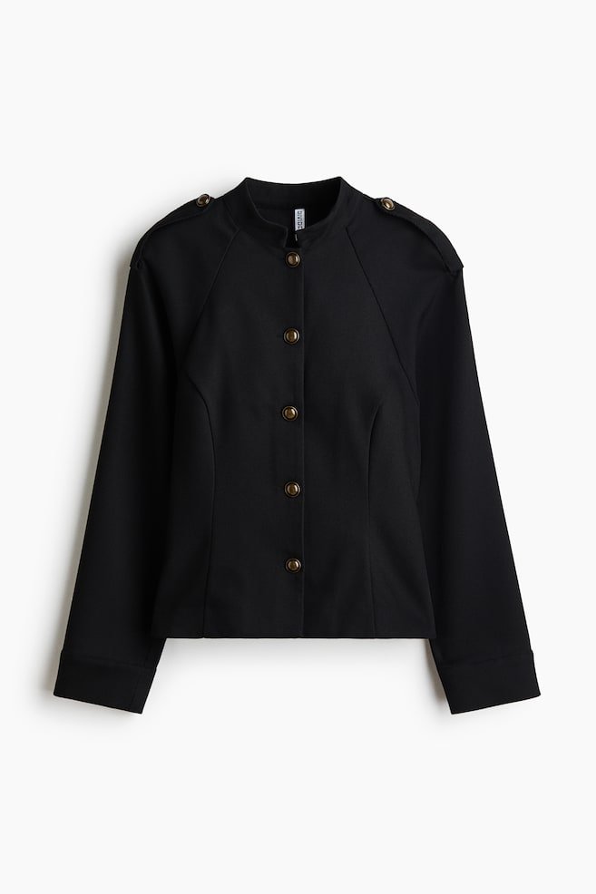 A structured black jacket is shown from the front, featuring a low band collar, shoulder epaulettes with metallic bronze-toned dome buttons, and a matching five-button front fastening. The design features curved seam detailing on the front bodice and long sleeves with wide, clean-finished cuffs. - 1