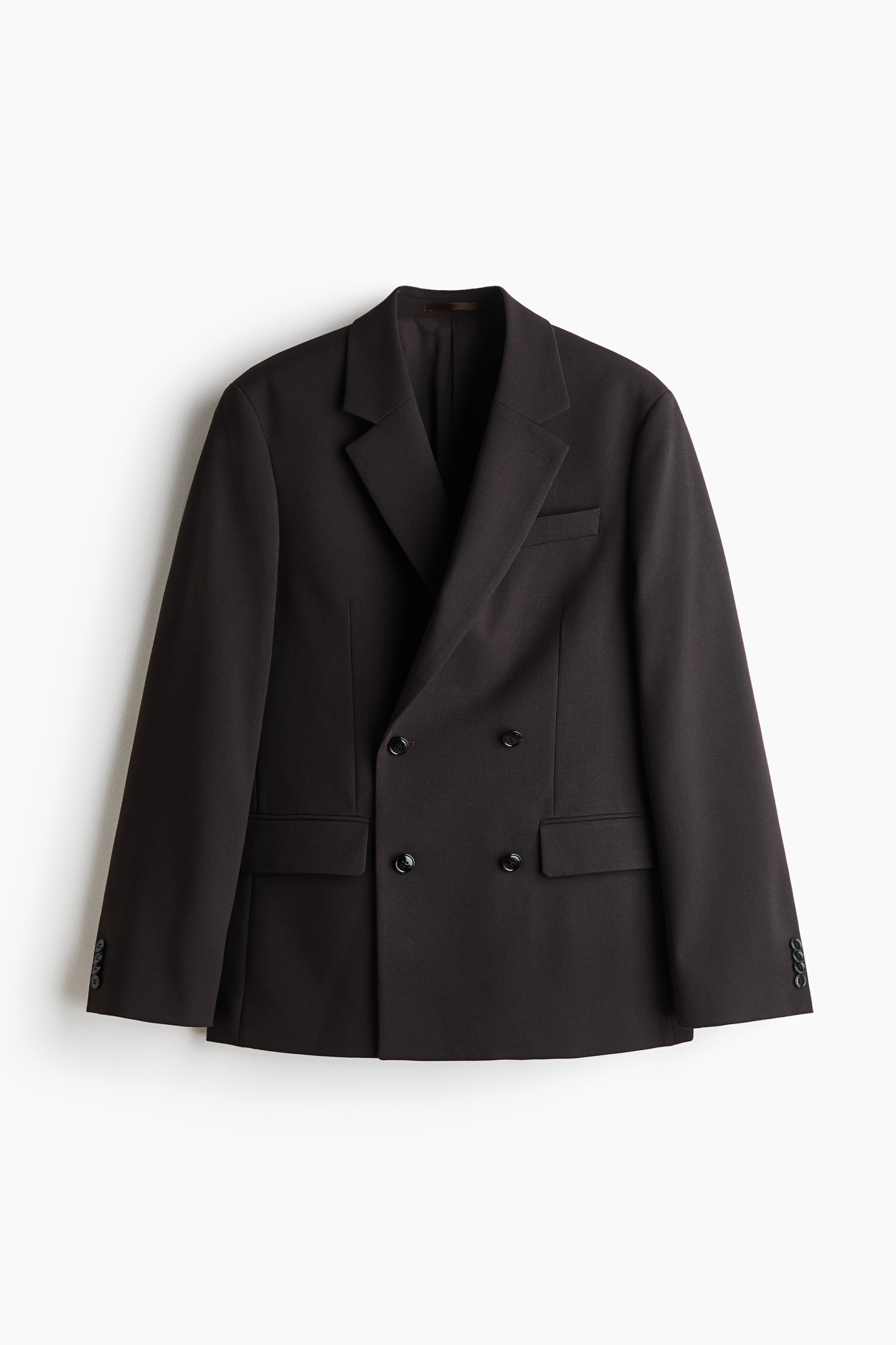 View larger image: A dark brown double-breasted blazer is shown front-on, featuring sharp notch lapels, a welt pocket on the left chest, and two lower flap pockets. The structured design includes a four-button front fastening and long sleeves finished with buttoned cuffs.