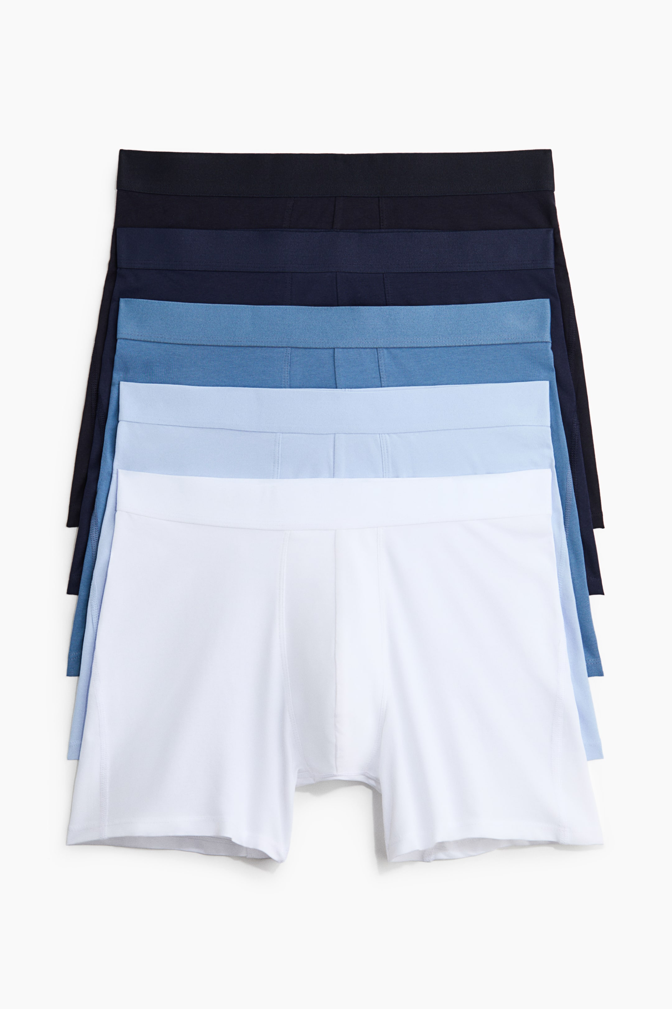 View larger image: Five boxer briefs are showcased in a stacked formation, illustrating a colour gradient from white to dark blue. Each pair features an elastic waistband and short legs.