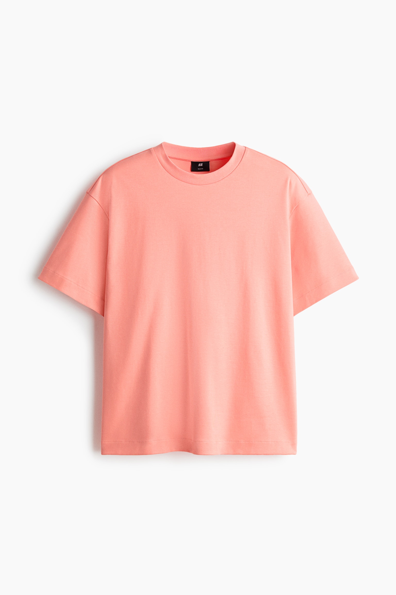 "A peach-colored, boxy-style t-shirt is presenting its front view, featuring a round, rib-trimmed neckline, dropped shoulders, and a straight-cut hem with a loose fit." - 1