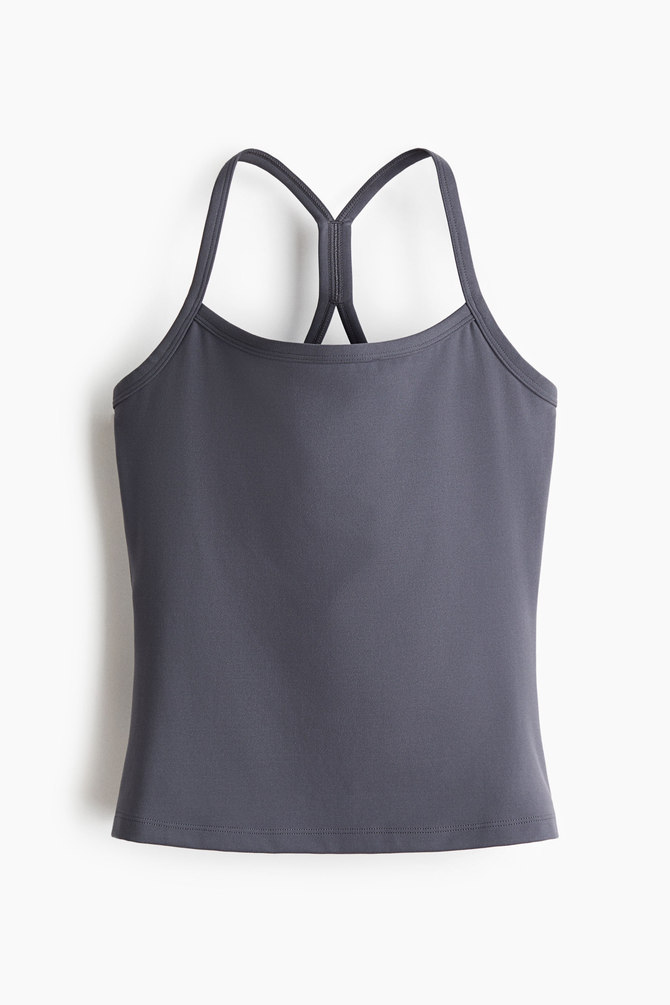 Ampliar la imagen: El top deportivo Integral-bra con tirantes es una prenda de color gris oscuro, mostrada desde el FRENTE, que presenta un escote redondo. Los tirantes delgados convergen en la parte posterior en un estilo de espalda cruzada, y el top termina con un dobladillo recto.