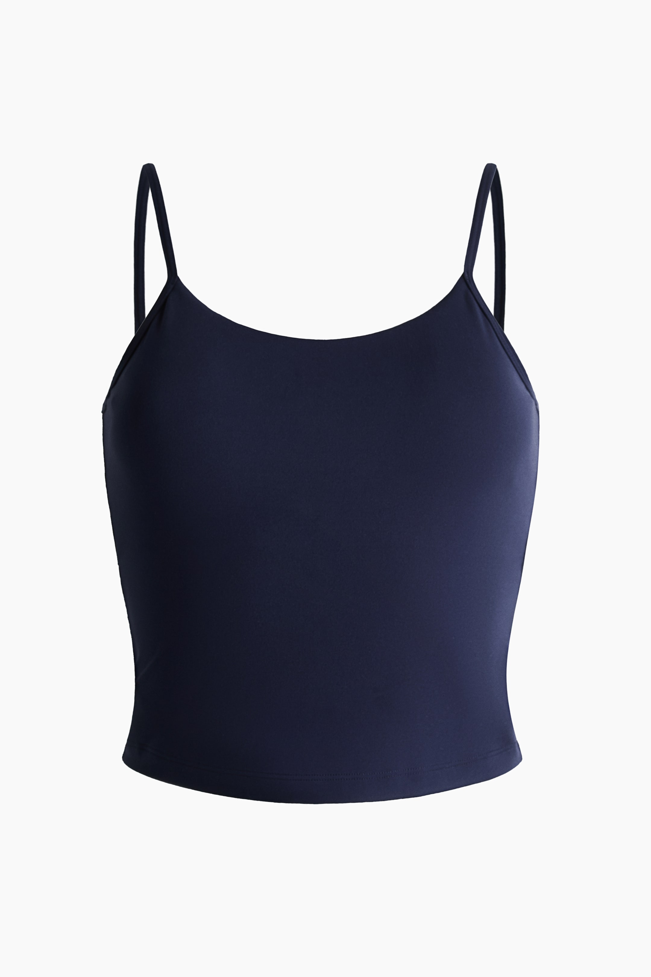 View larger image: A navy blue cropped camisole top is shown front-facing, showcasing a scoop neckline and thin spaghetti straps. Crafted from a smooth, solid fabric, it features a straight hem.