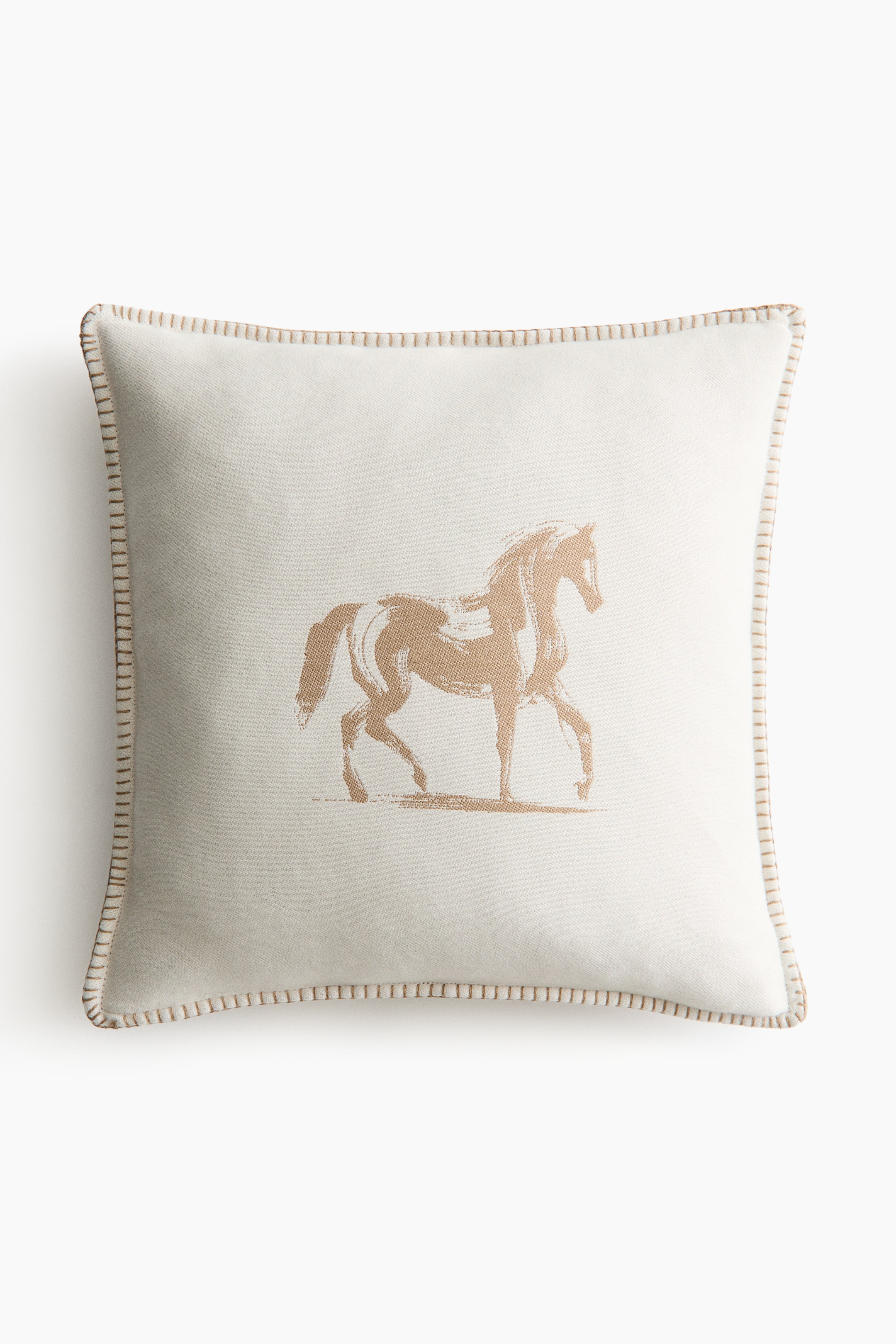 View larger image: A square cushion featuring an off-white fabric with a tan brushstroke-style horse illustration at its centre, facing forward. Decorative tan stitching outlines all four edges.