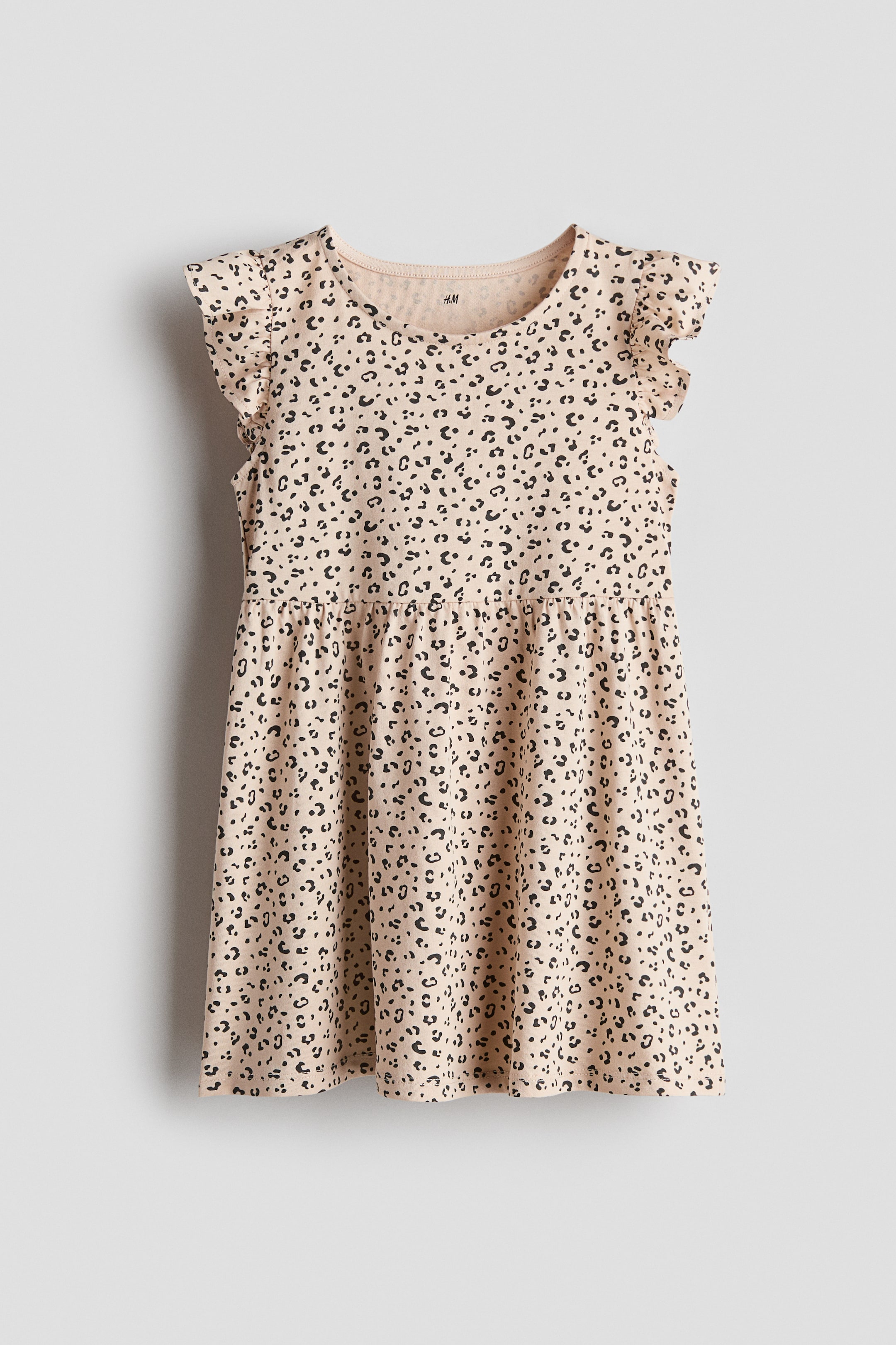 View larger image: A front-facing beige dress with black leopard-print detailing displays a round neckline and short ruffled sleeves. A gathered seam defines the waist and transitions to a flared skirt.