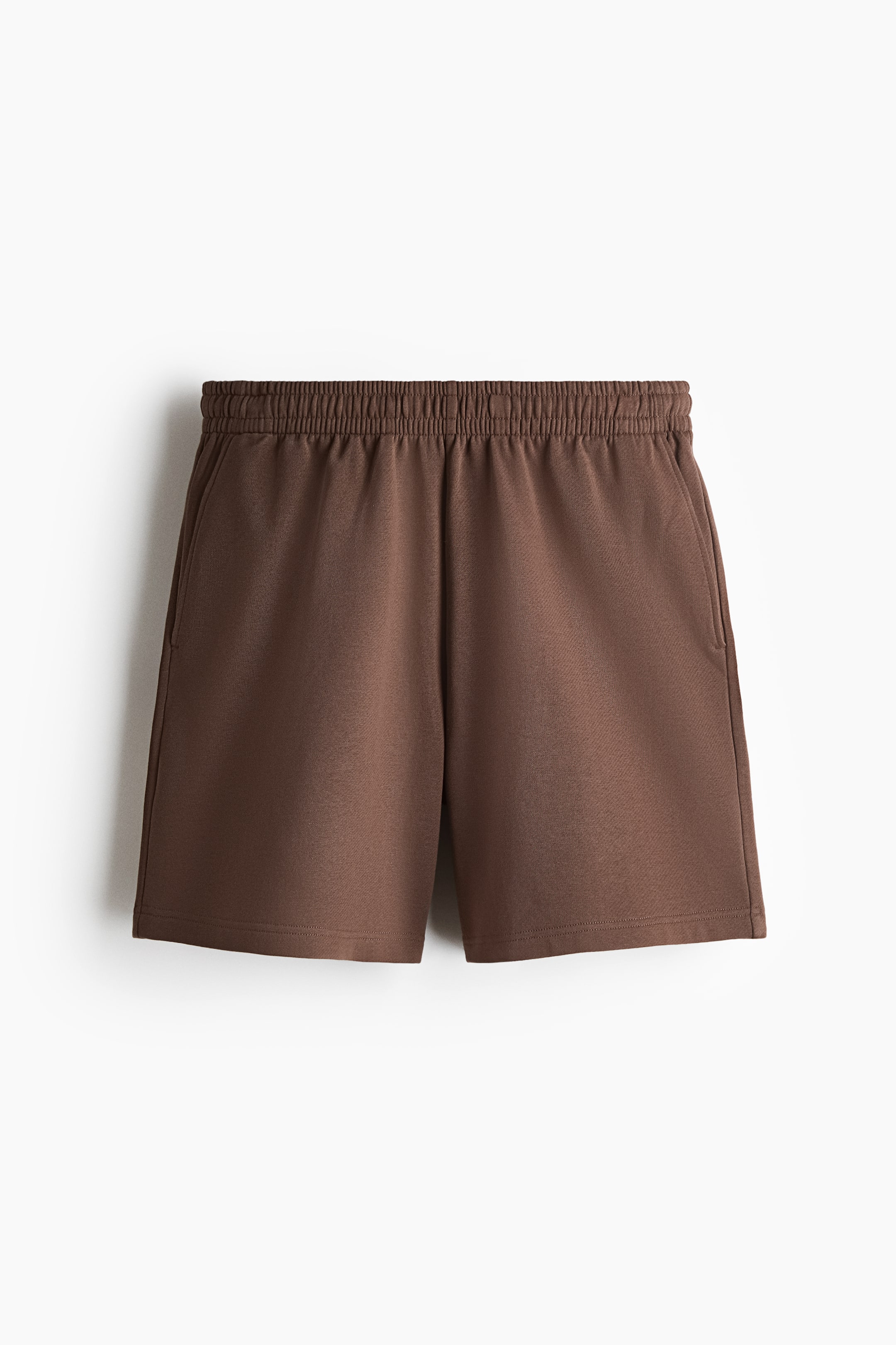 View larger image: Brown sweatshirt fabric shorts, viewed from the front, include an elasticated waist and side pockets, offering a regular fit.