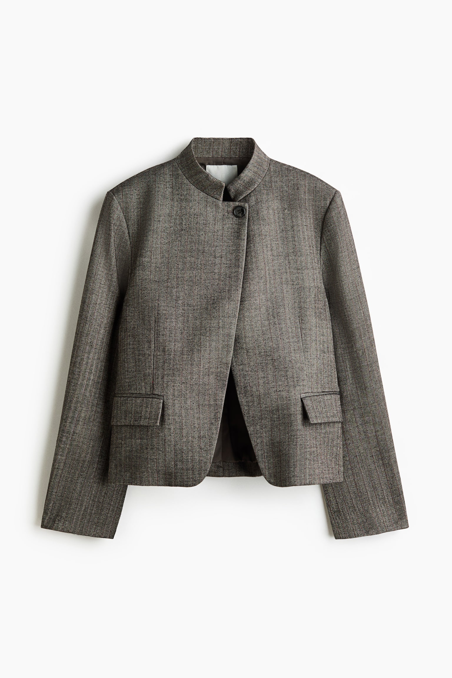 A single-breasted blazer in a grey-brown woven fabric is shown from the front, featuring a stand collar, a lapelless neckline, and a single-button fastening at the top. The boxy, oversized-fit blazer is styled with padded shoulders, front waist darts, and two jetted pockets with flaps. - 1