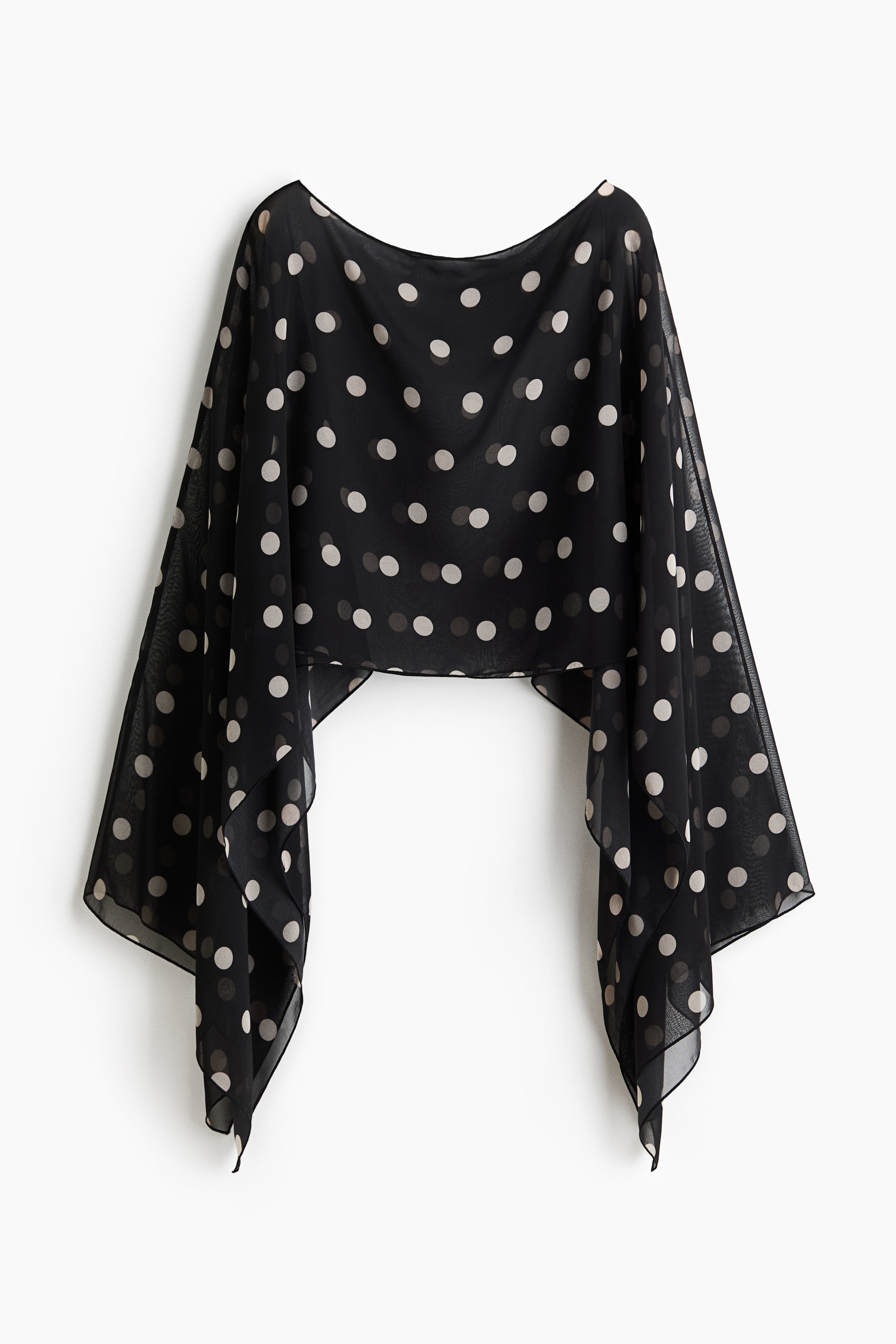 Größeres Bild ansehen: Ein schwarzer, transparenter Chiffon-Wickel ist mit einem cremefarbenen Pünktchenmuster überzogen. Das Kleidungsstück fällt weich mit einem geschwungenen Halsausschnitt und langen, locker fallenden Seitenteilen, die sich zum Ende hin verjüngen.
