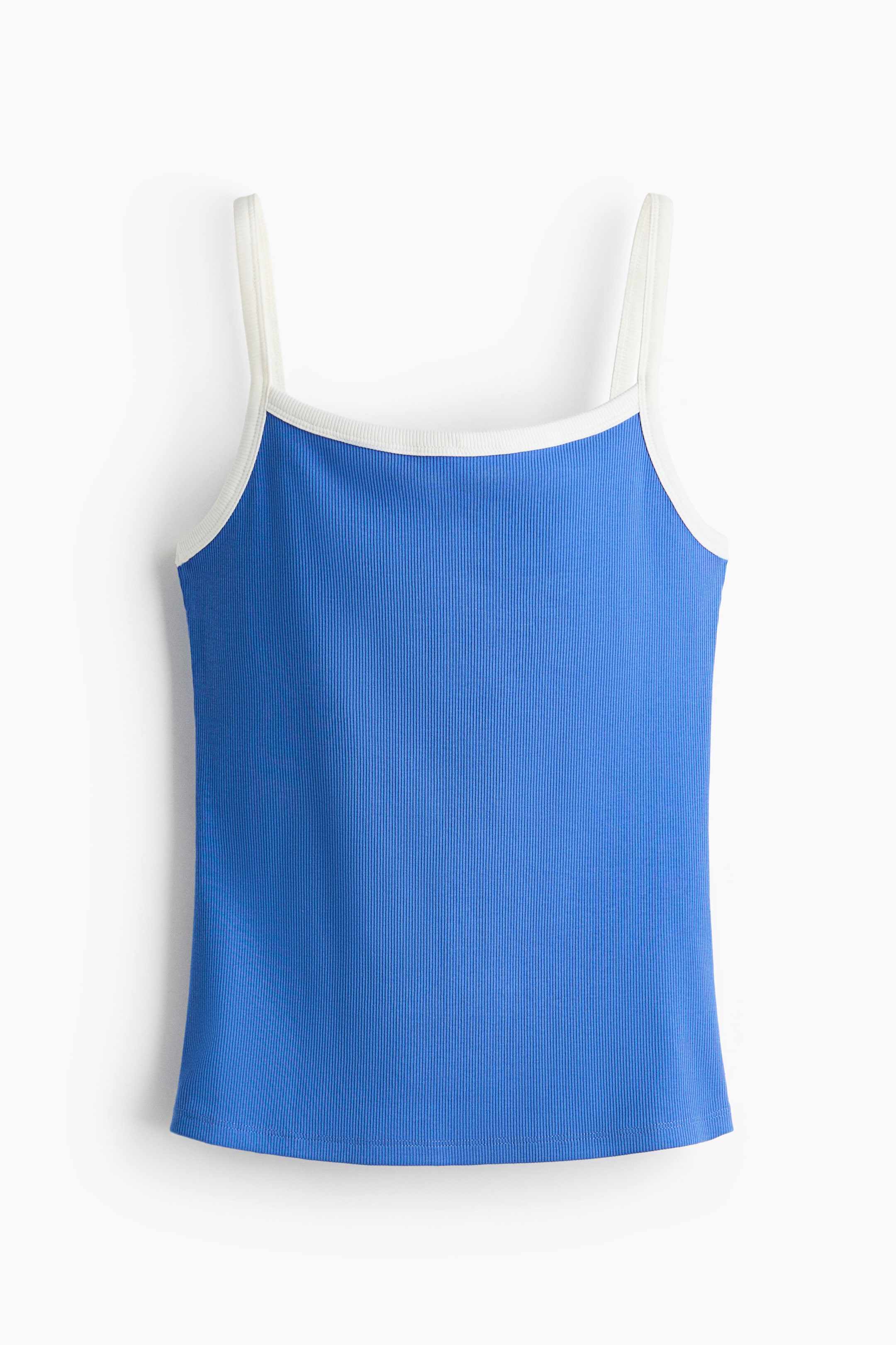 View larger image: A fitted top in blue ribbed cotton jersey is displayed from the front. It features a scoop neckline and narrow shoulder straps, both trimmed with white.