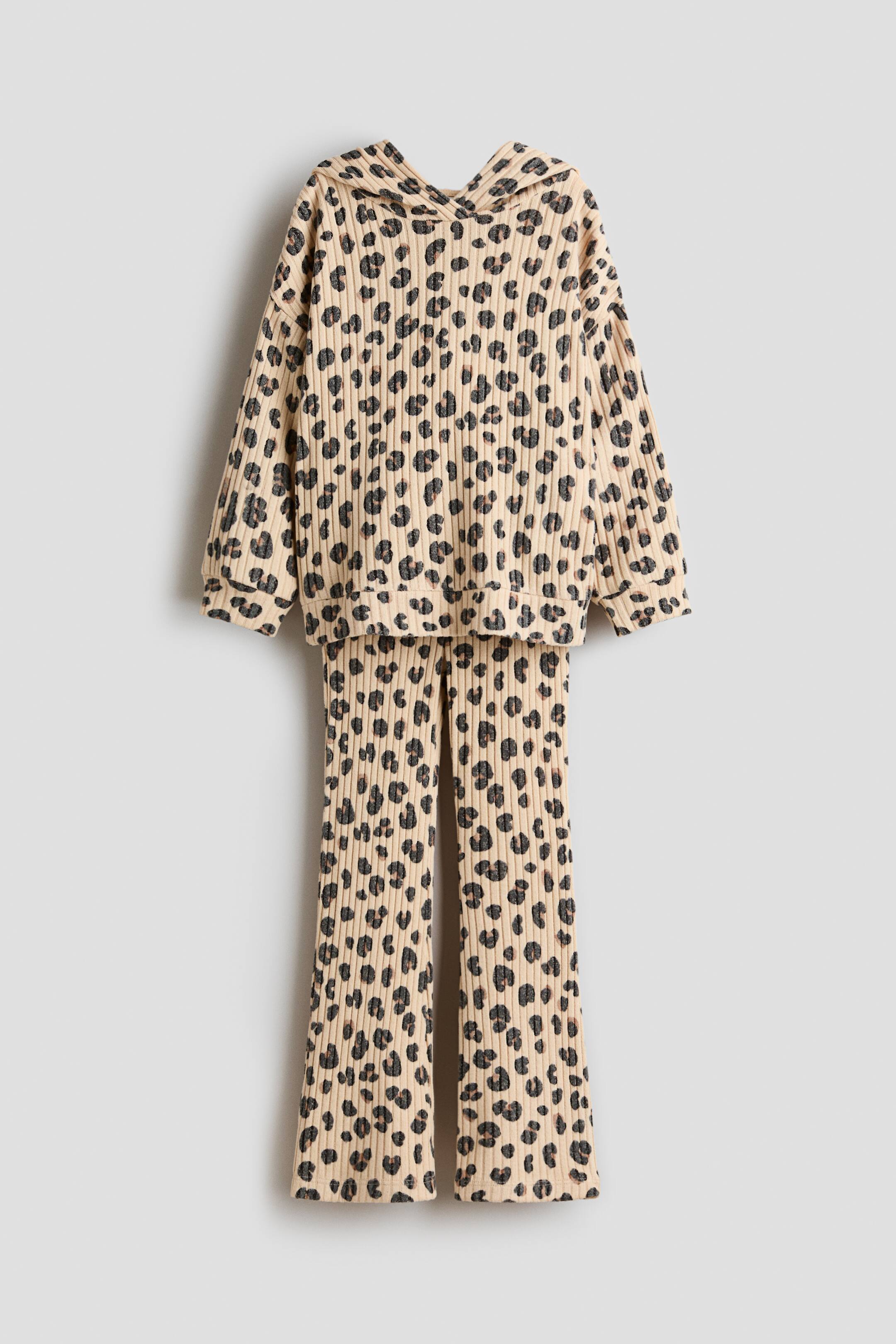 View larger image: A two-piece set, presented as FRONT, is featuring a hoodie and leggings in a ribbed knit with a leopard print. The hoodie is showcasing a wrapover hood, dropped shoulders, and ribbed cuffs and hem, while the leggings are displaying a covered elasticated waist and gently flared hems.