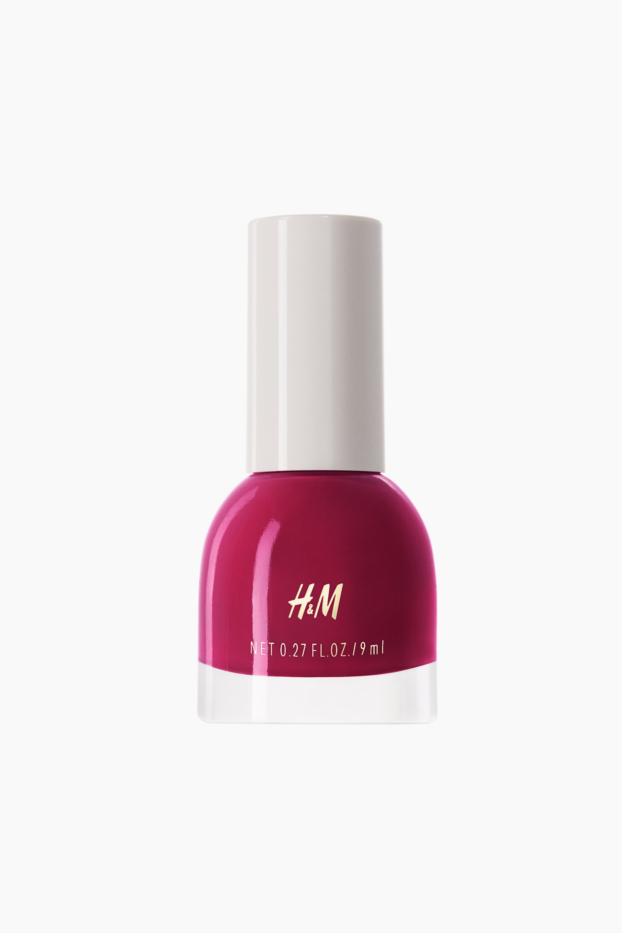 View larger image: A nail polish bottle is positioned upright and facing forward, showcasing a lively fuchsia-coloured polish encased within a transparent glass bottle. It features a rounded upper body and a white cylindrical cap, with the H&M logo elegantly displayed in gold lettering and the net volume clearly marked in white on the bottle.