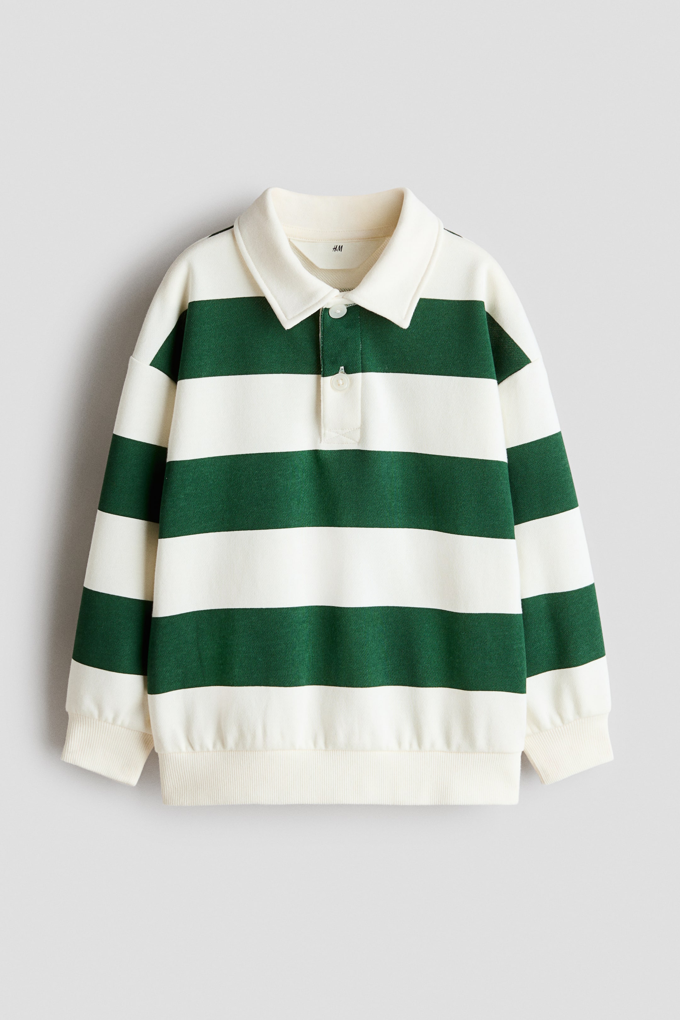 View larger image: A rugby shirt crafted from lightweight sweatshirt fabric showcases green and off-white horizontal stripes. It features an off-white collar, a two-button placket, dropped shoulders, and long sleeves with ribbed cuffs and a ribbed hem.