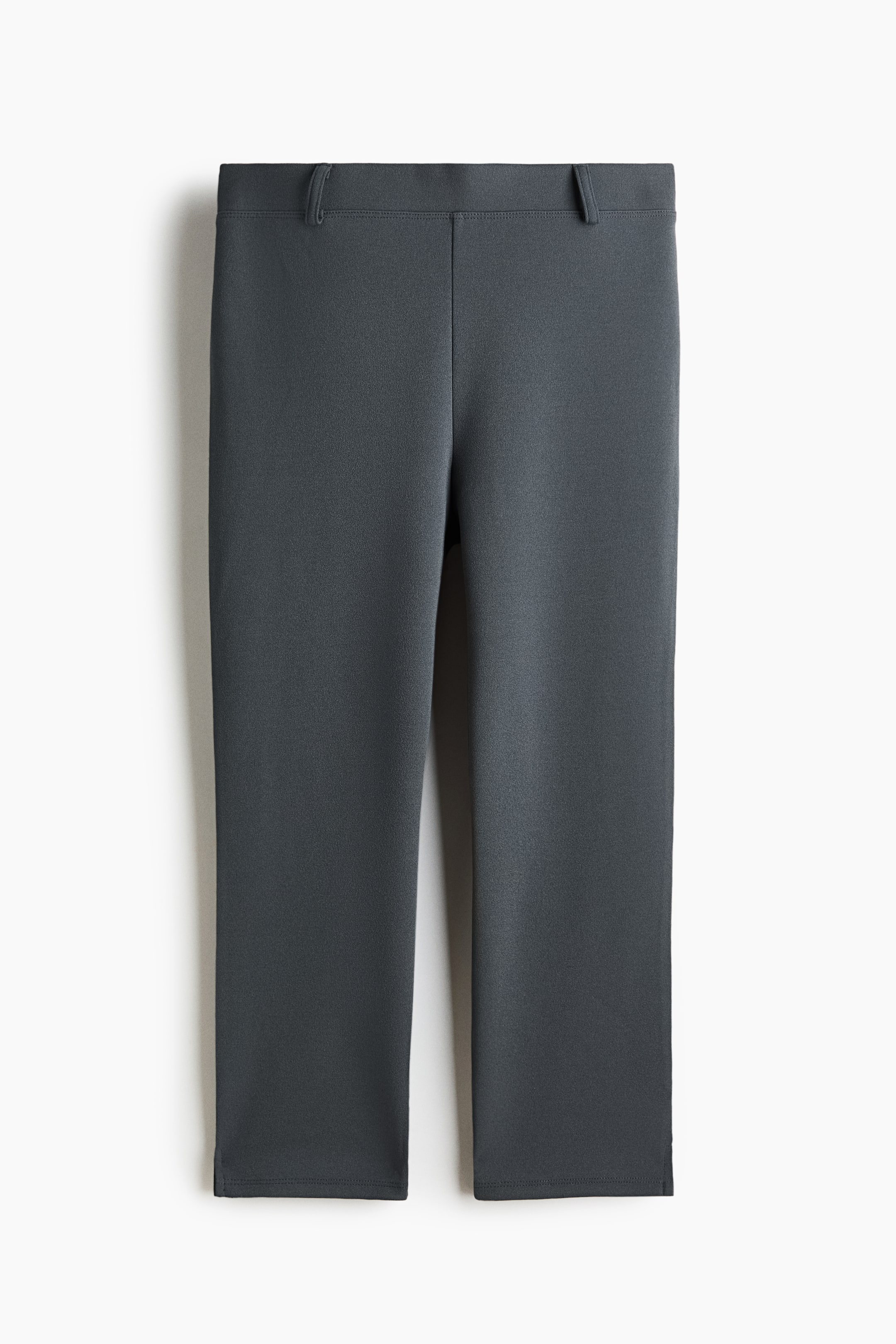 View larger image: Dark grey trousers showcase a sleek flat front and a structured waistband complete with belt loops. The straight-leg cut features a neat hem, accented with a subtle side slit at the outer ankle.