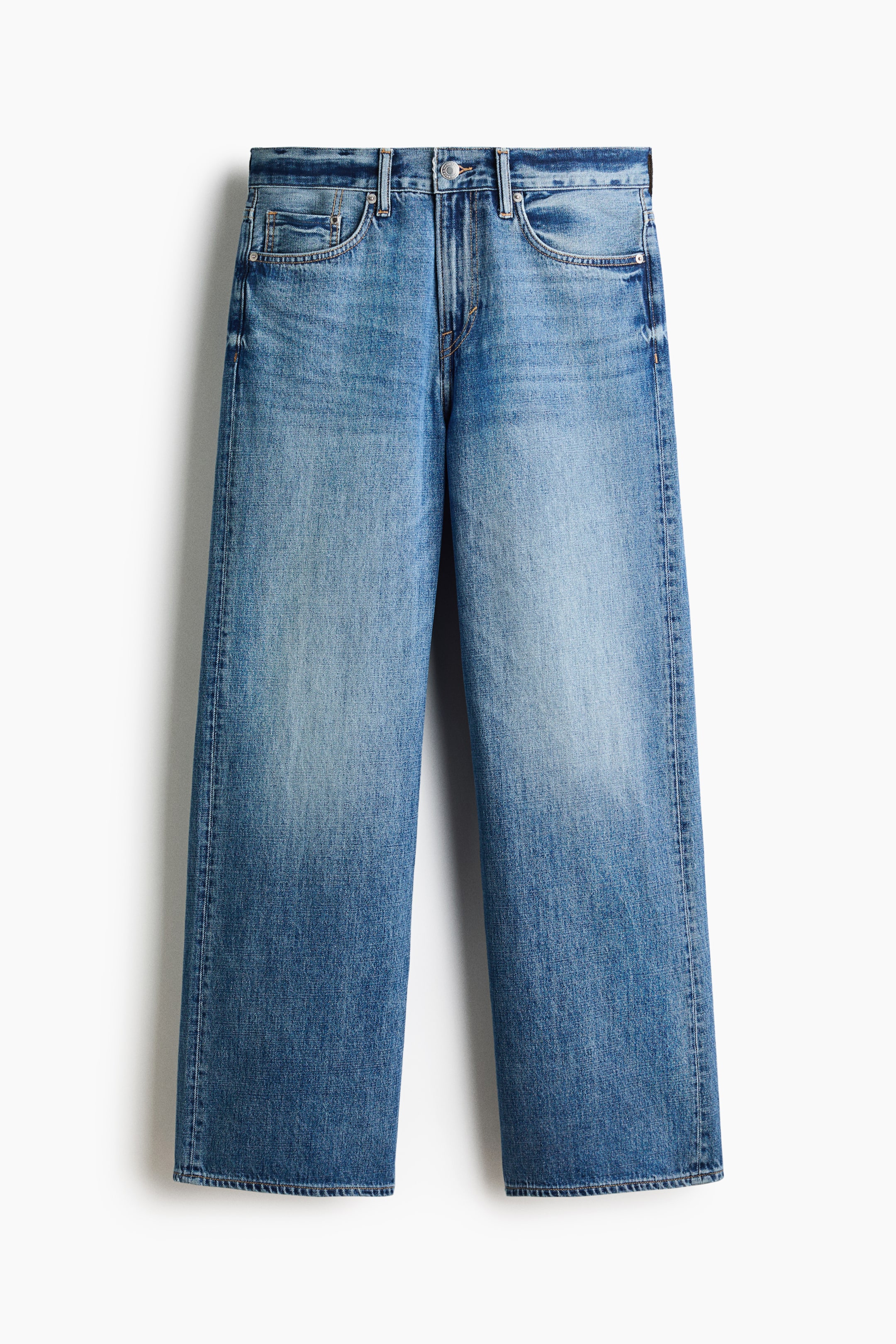 View larger image: Five-pocket jeans are showcased in a front view, crafted from durable blue cotton denim with a medium wash and gentle fading. They boast a regular waist, a button fly, and a dropped crotch, seamlessly transitioning into a straight leg with a relaxed fit and ample space throughout.