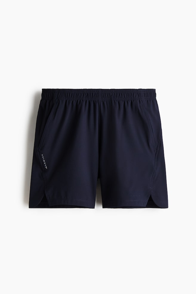 Navy shorts feature an elasticated waistband, side pockets and small side slits at the leg openings. A "DRYMOVE?" logo appears vertically on the front left. - 1