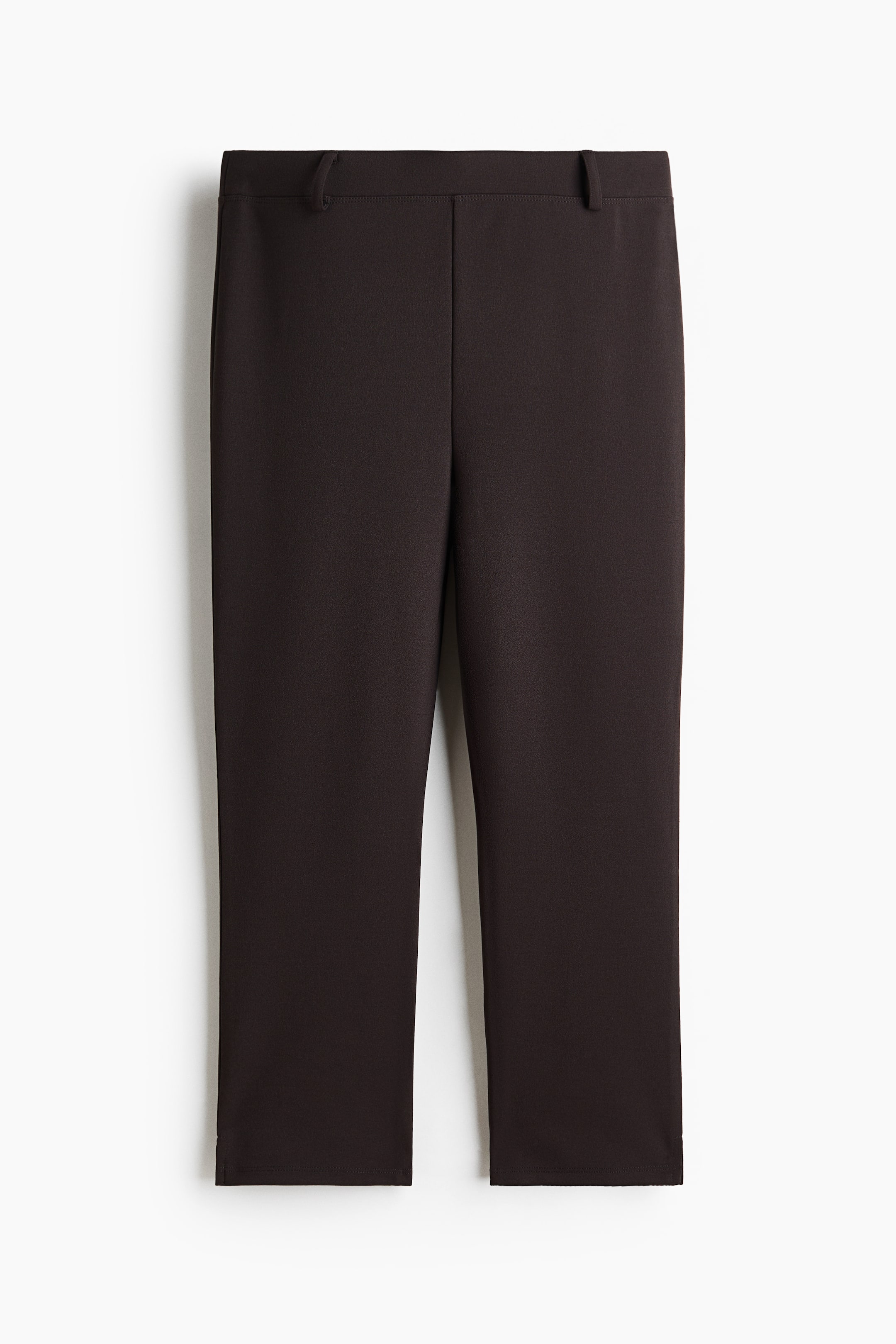 View larger image: Dark brown cropped pants are shown from the front, featuring a smooth, flat waistband with two visible belt loops and a clean, straight-leg cut.