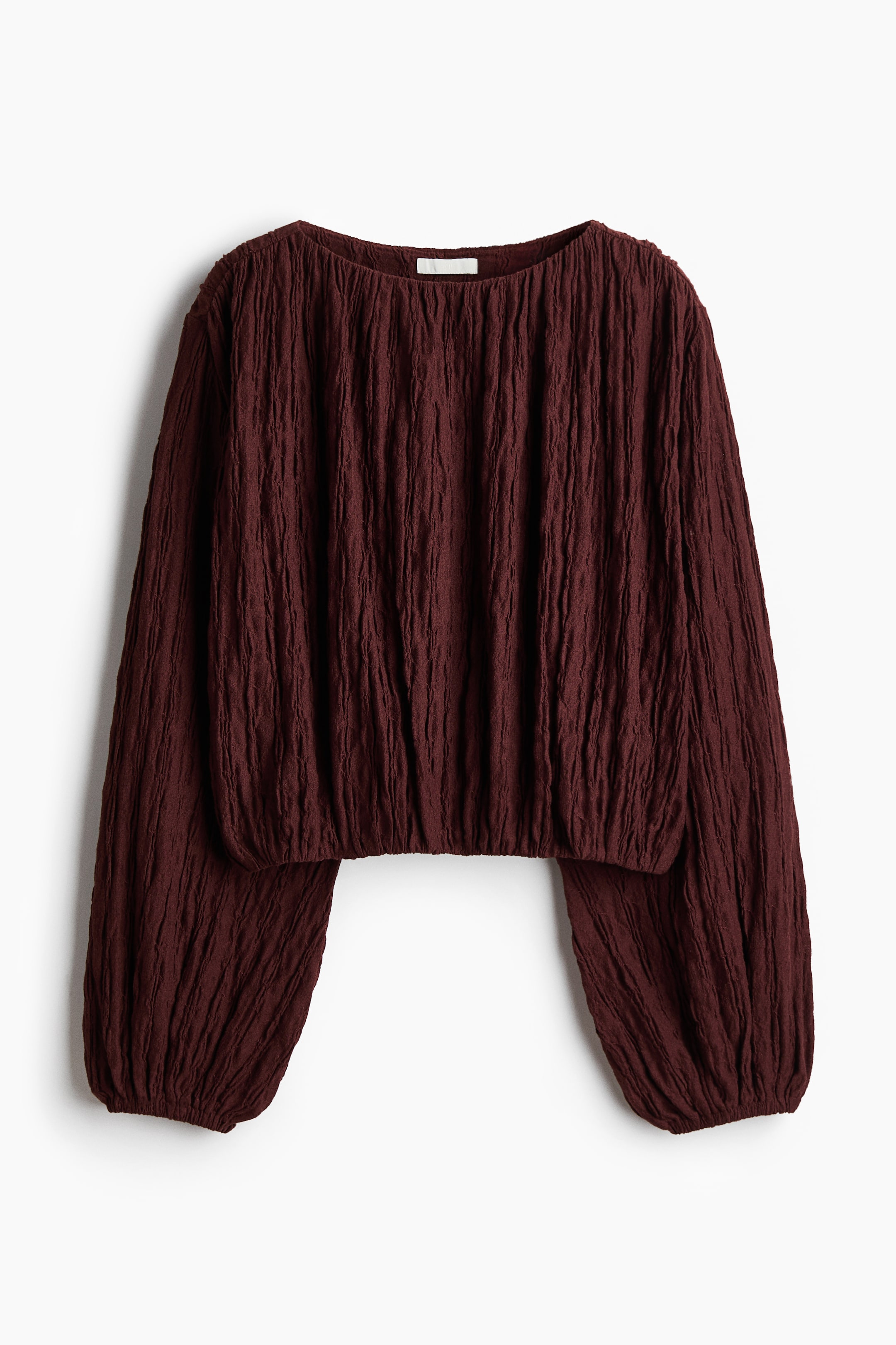 View larger image: Front view of a deep red long-sleeved top showcasing a richly crinkled texture all over, with a broad round neckline, billowy sleeves cinched at the cuffs, and a gathered cropped hem.