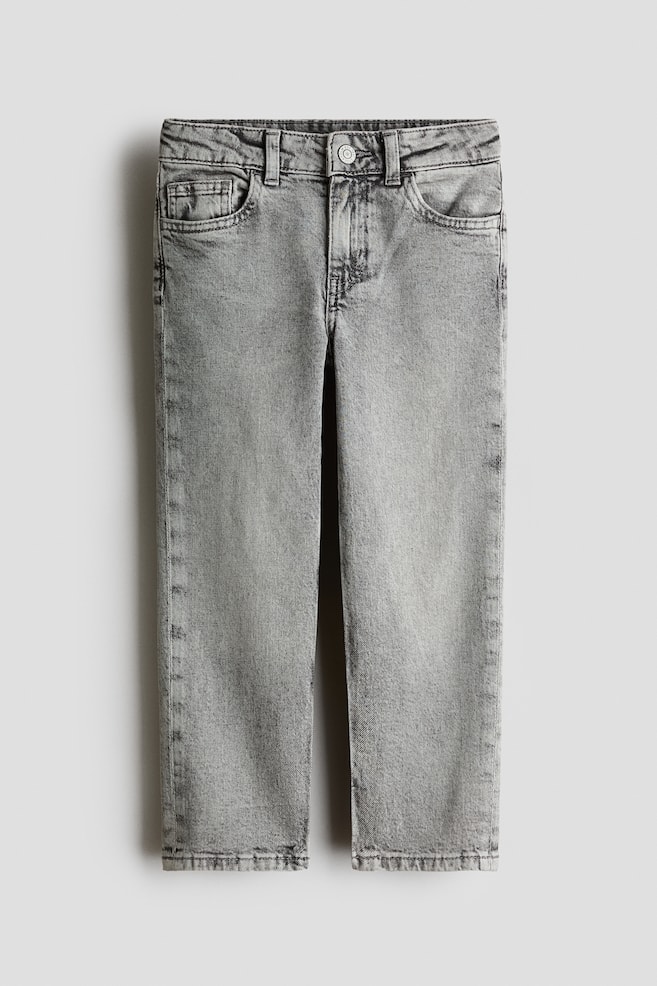 A pair of light grey washed denim jeans is shown from the front, featuring a relaxed-fit design with a classic five-pocket layout, belt loops, and a single metal button closure at the centre of the waistband. - 1