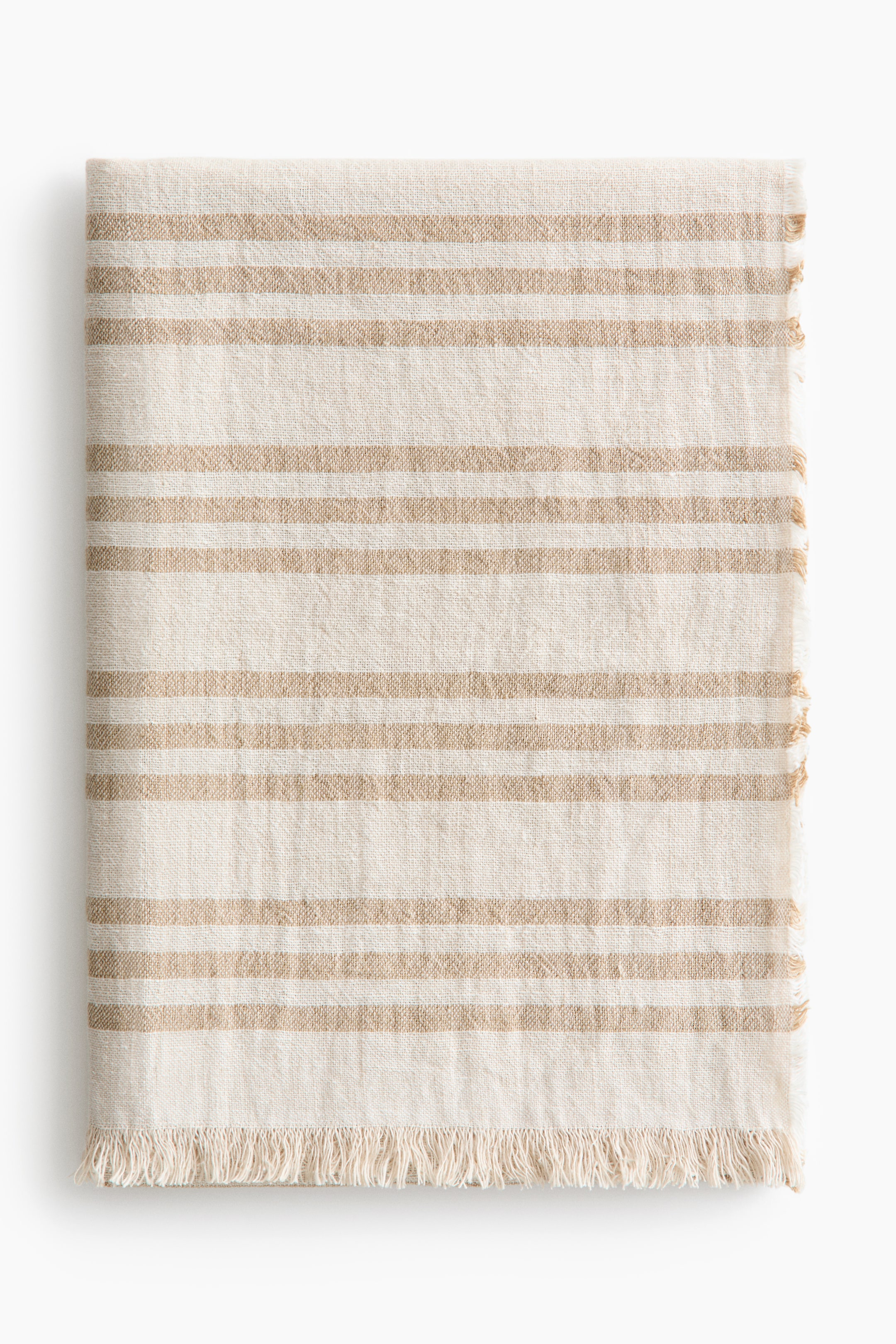 View larger image: A folded rectangular fabric showcases horizontal stripes in alternating cream and light brown, with fringed edges on the right and bottom.