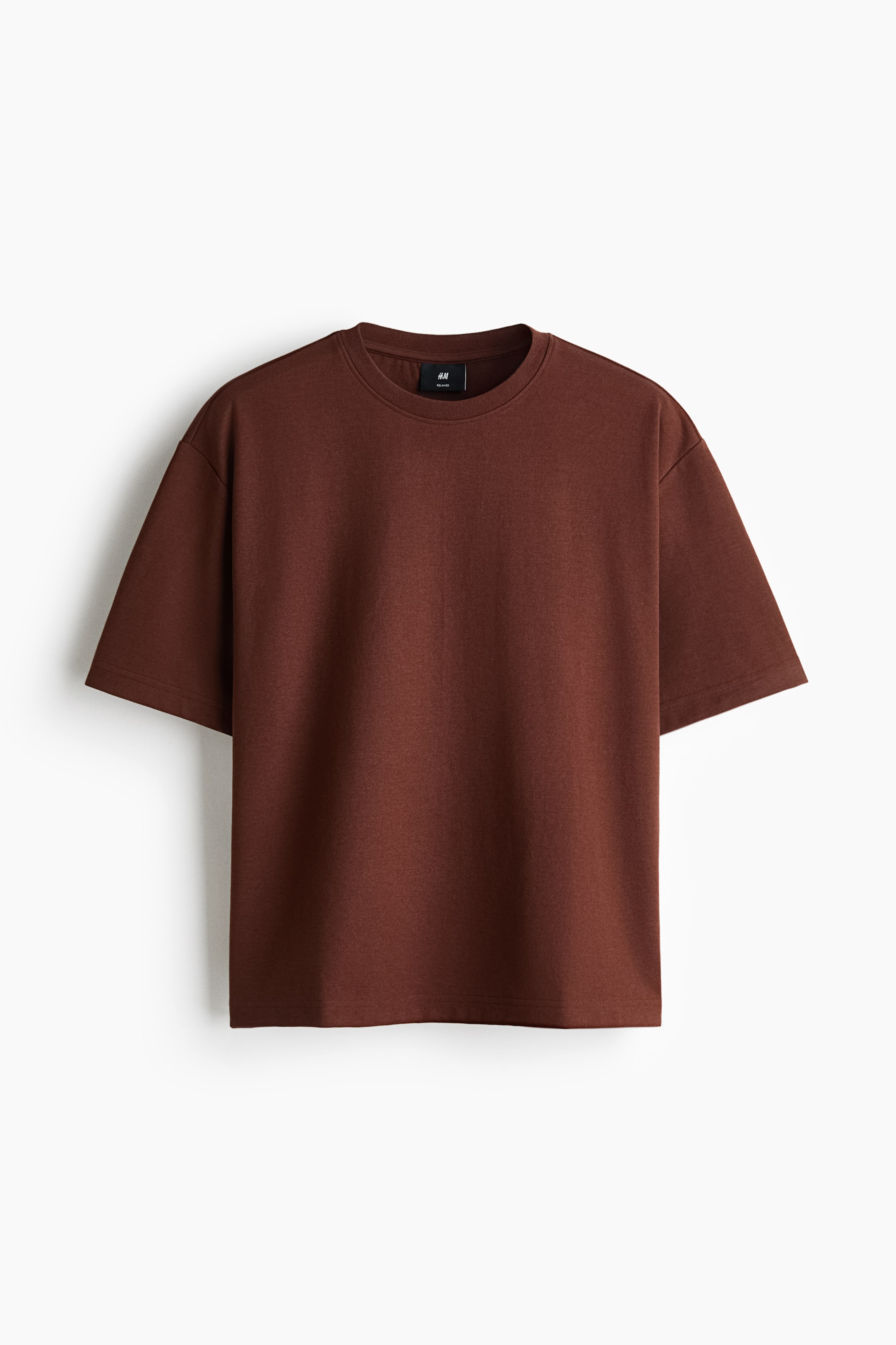 View larger image: A dark brown heavyweight jersey T-shirt is facing front, showing a relaxed fit with a round ribbed neckline, dropped shoulders, and a straight-cut hem.