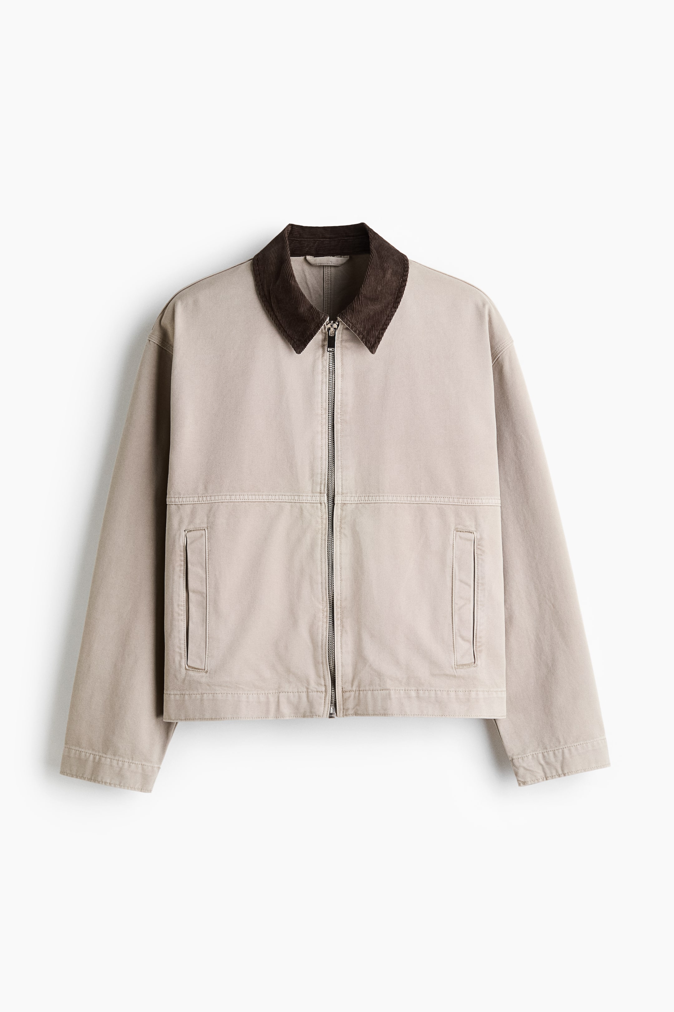 View larger image: A light beige jacket featuring a dark brown corduroy collar and a full silver zipper closure, showcasing two front patch pockets with vertical openings and a straight hemline.
