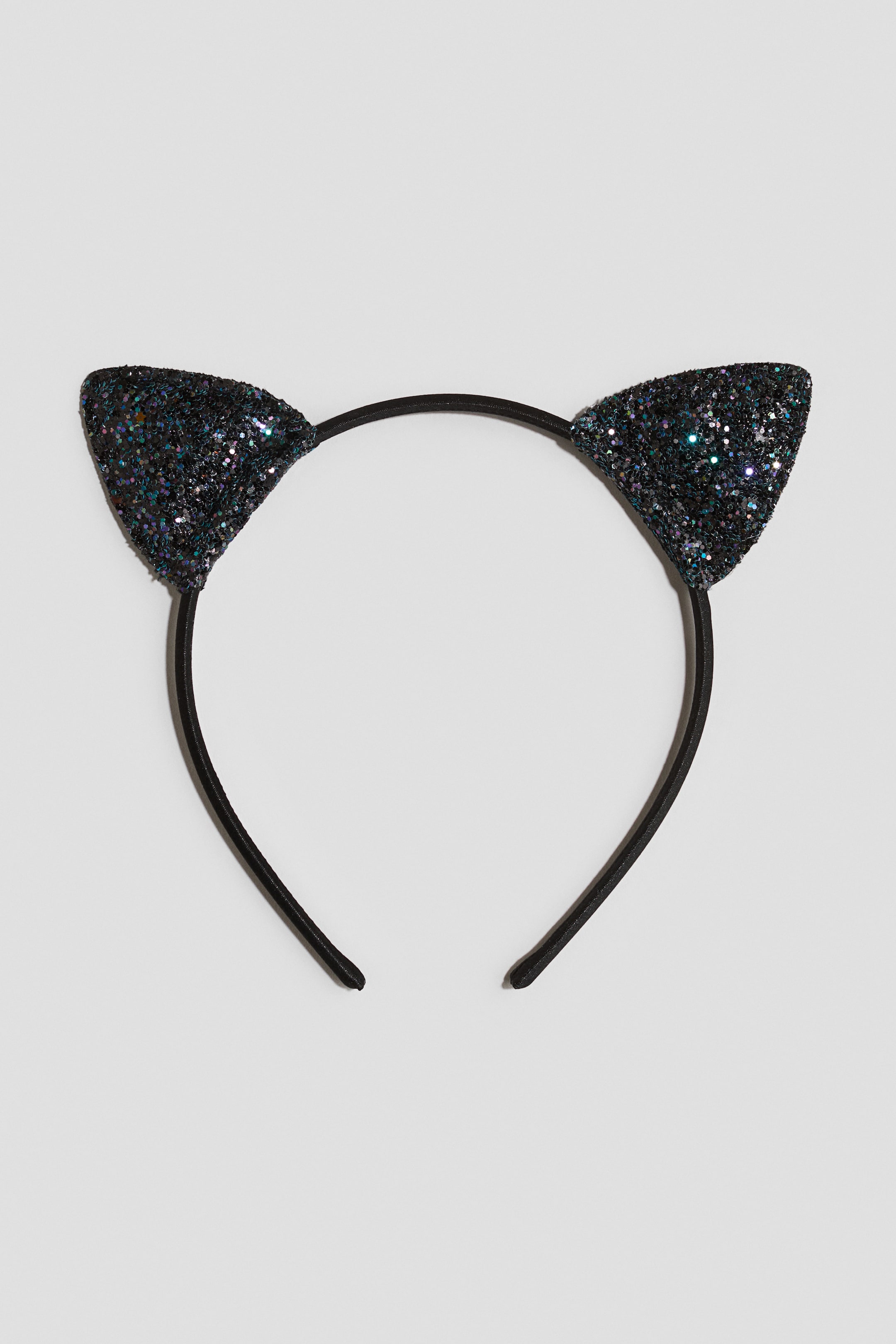 View larger image: A black headband features two pointed, triangular cat ears. The ears are covered in iridescent black glitter, showcasing specks of blue, green, and purple.